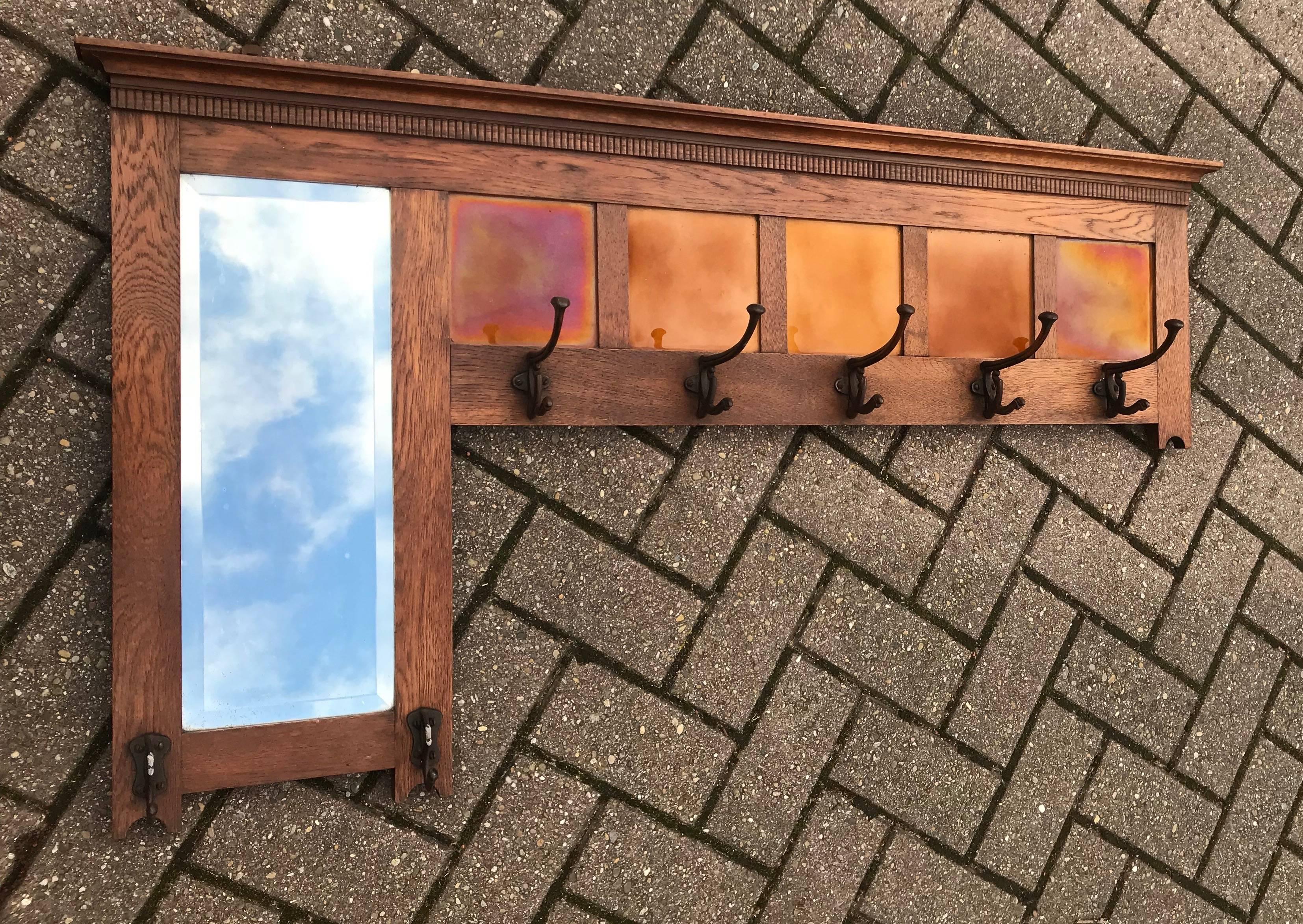 Good size Arts and Crafts wall coat rack. 

This rare and stylish Arts and Crafts coat rack is entirely original and in very good condition. This top quality coat rack is handcrafted from solid oak. The inlaid Majolica glazed tiles have a beautiful,