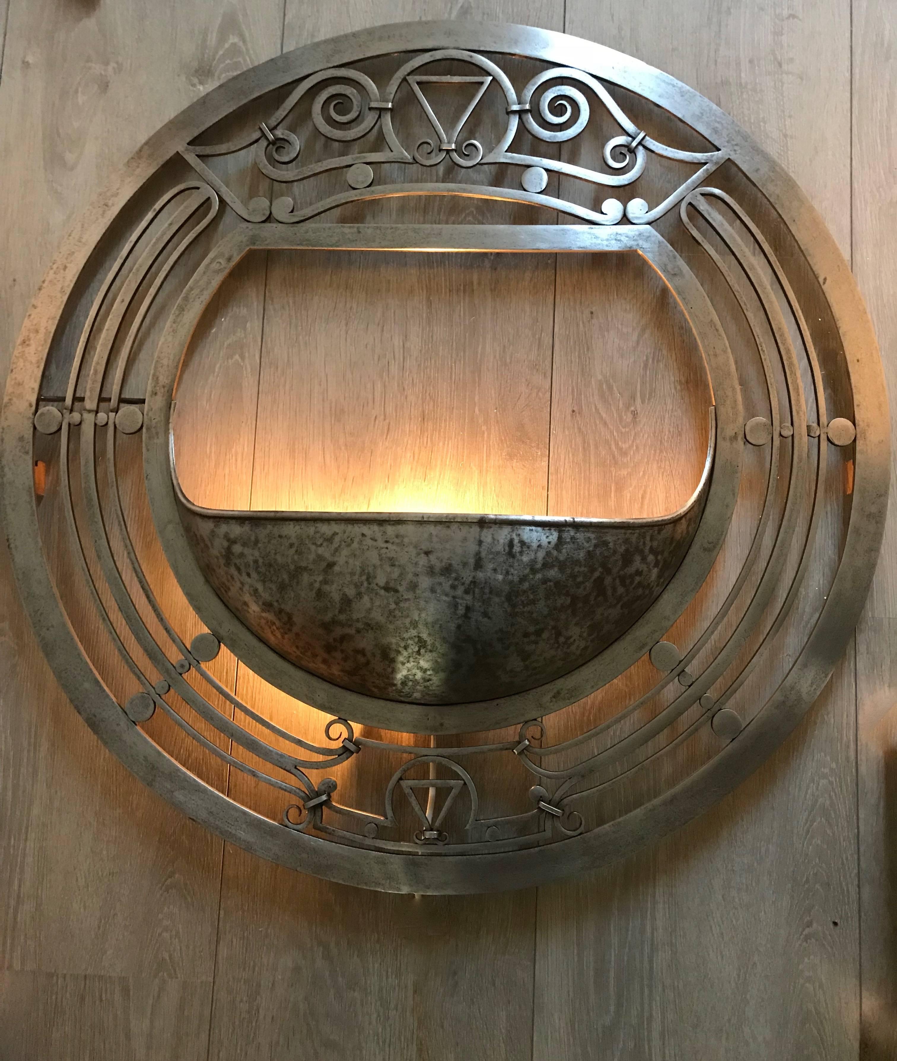 Unique and impressive wall light.

If you are a collector of rare Arts and Crafts lamps with a taste of modernism then this large and very stylish wall light could be perfect for you. The impressive and symmetrical shape is almost like the front