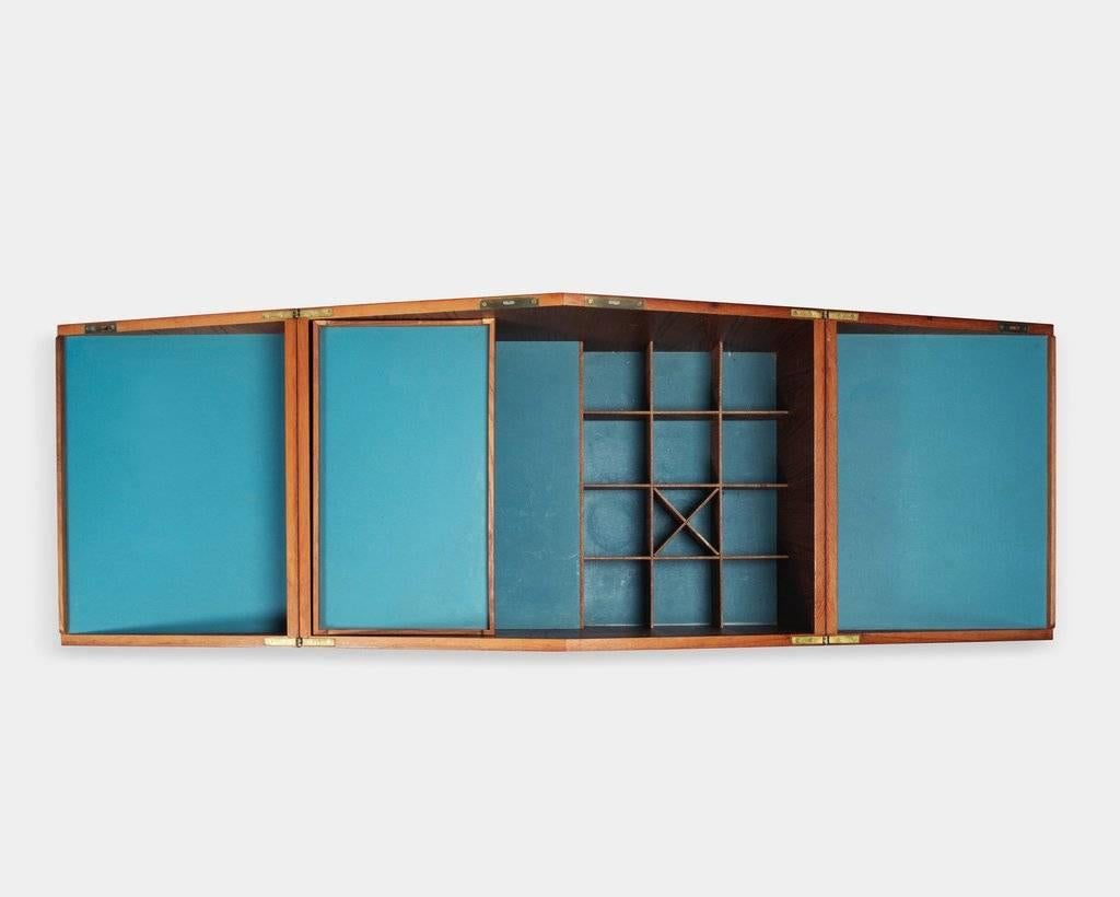 Leif Alring (1936-1987):
Unfolding bar cabinet or model 284.
Veneered teak bar on wheels with blue formica inlay.
Cabinet designed with lockable top, removable tray and compartments for glasses and bottles.
Designed in 1964, produced by C. F.