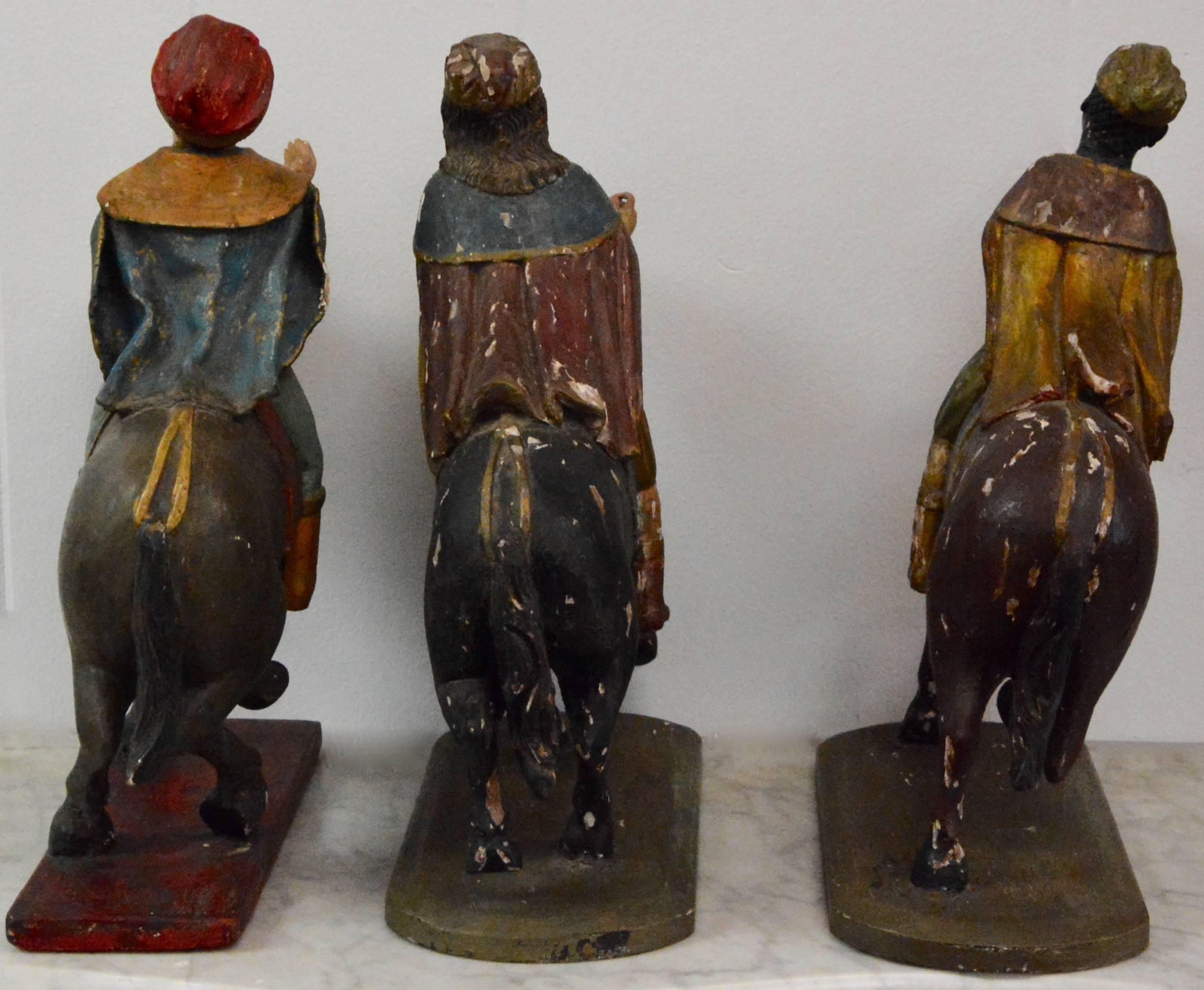 These figures depict the three wise men on horseback. Each figure has polychrome paint decoration on carved wood and glass inset edges. These are from a private Manhattan residence of the Pierre Hotel in New York City. They emit a beauty from days