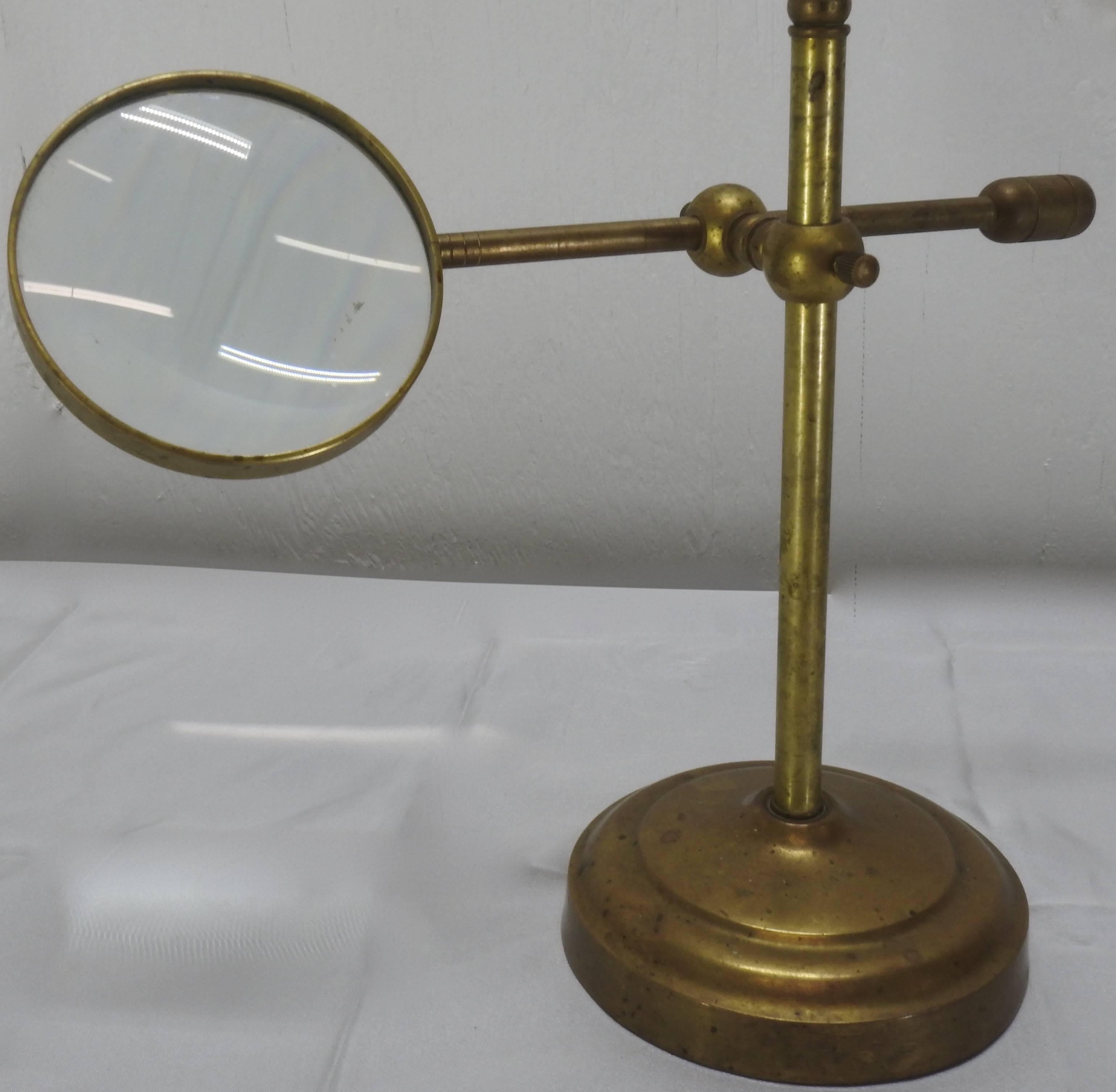 This Classic industrial style magnifier rests on a stand and is adjustable. You can move it up and down and side to side. It also rotates. This is just what you need to help you view your valuables! It has a beautiful aged patina.