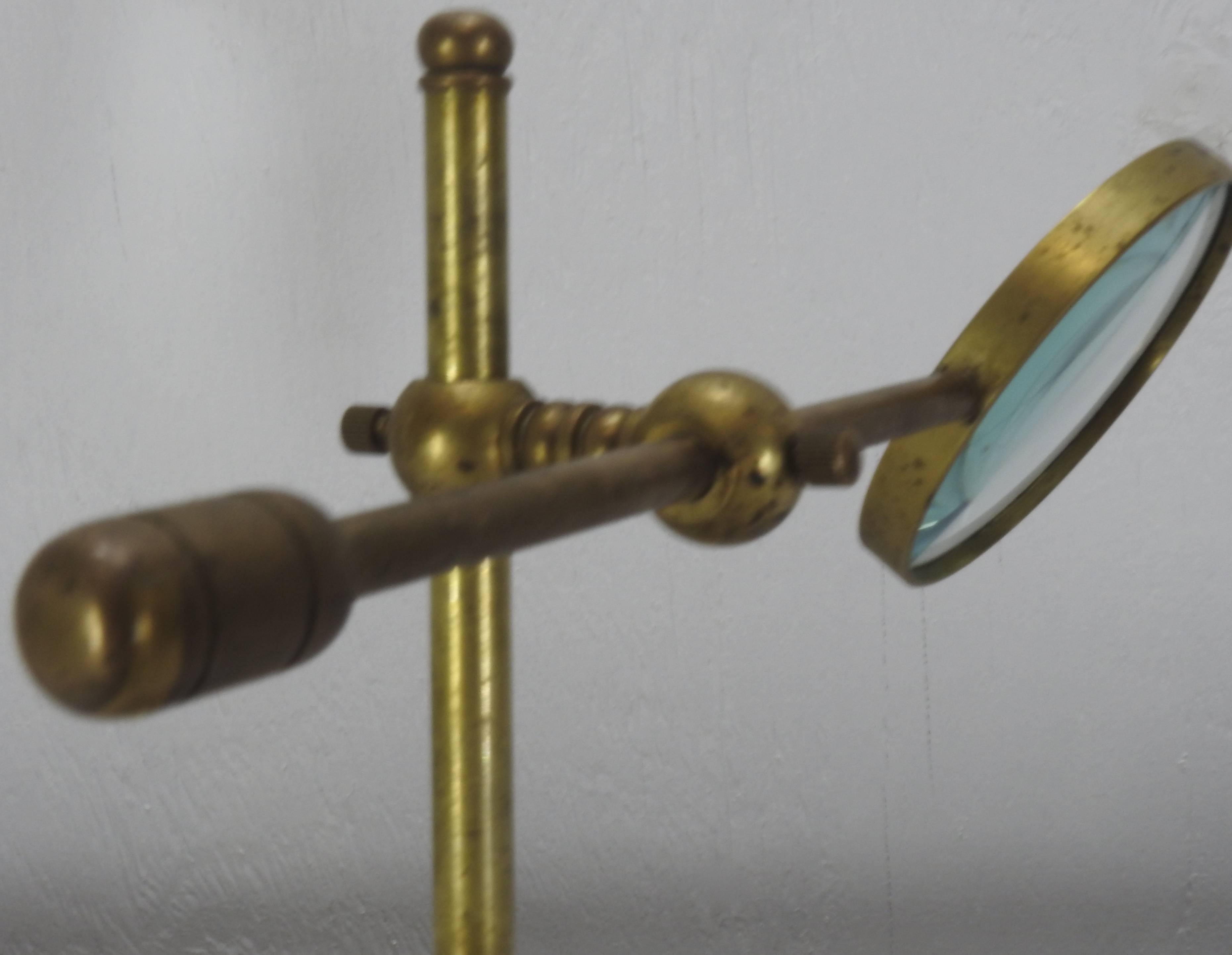 brass magnifying glass on stand