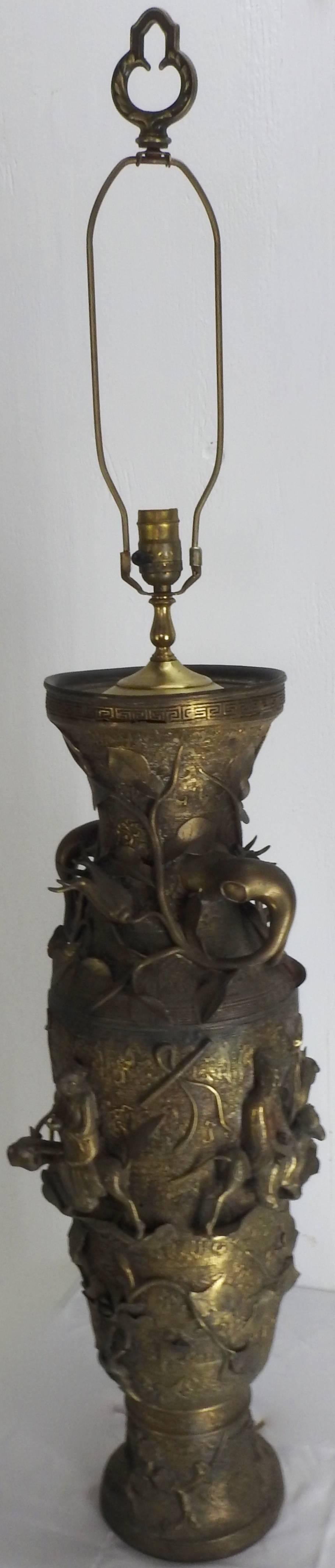 The detailed repousse metalwork on this magnificent bronze lamp featuring water buffalo with riders is outstanding! The intricate design is highlighted with flowers and vines twining through the design. It includes the harp to mount your shade and