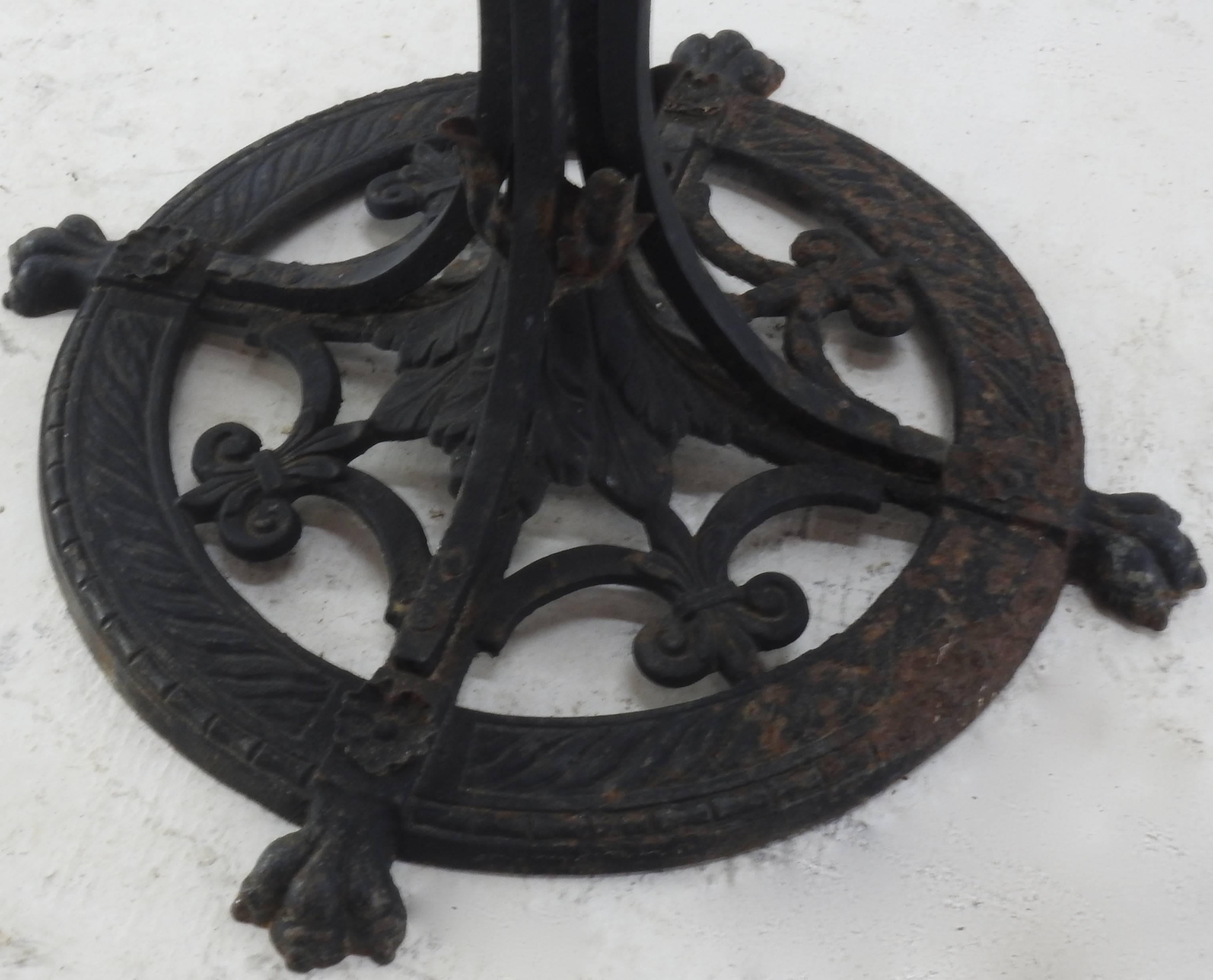 Classic Fleur de Lis pattern is on the base of this hand forged wrought iron plant stand. The center column is made up of four twisted bars that angle near the top to support your planter. It is accented with rings at the top of each bar.