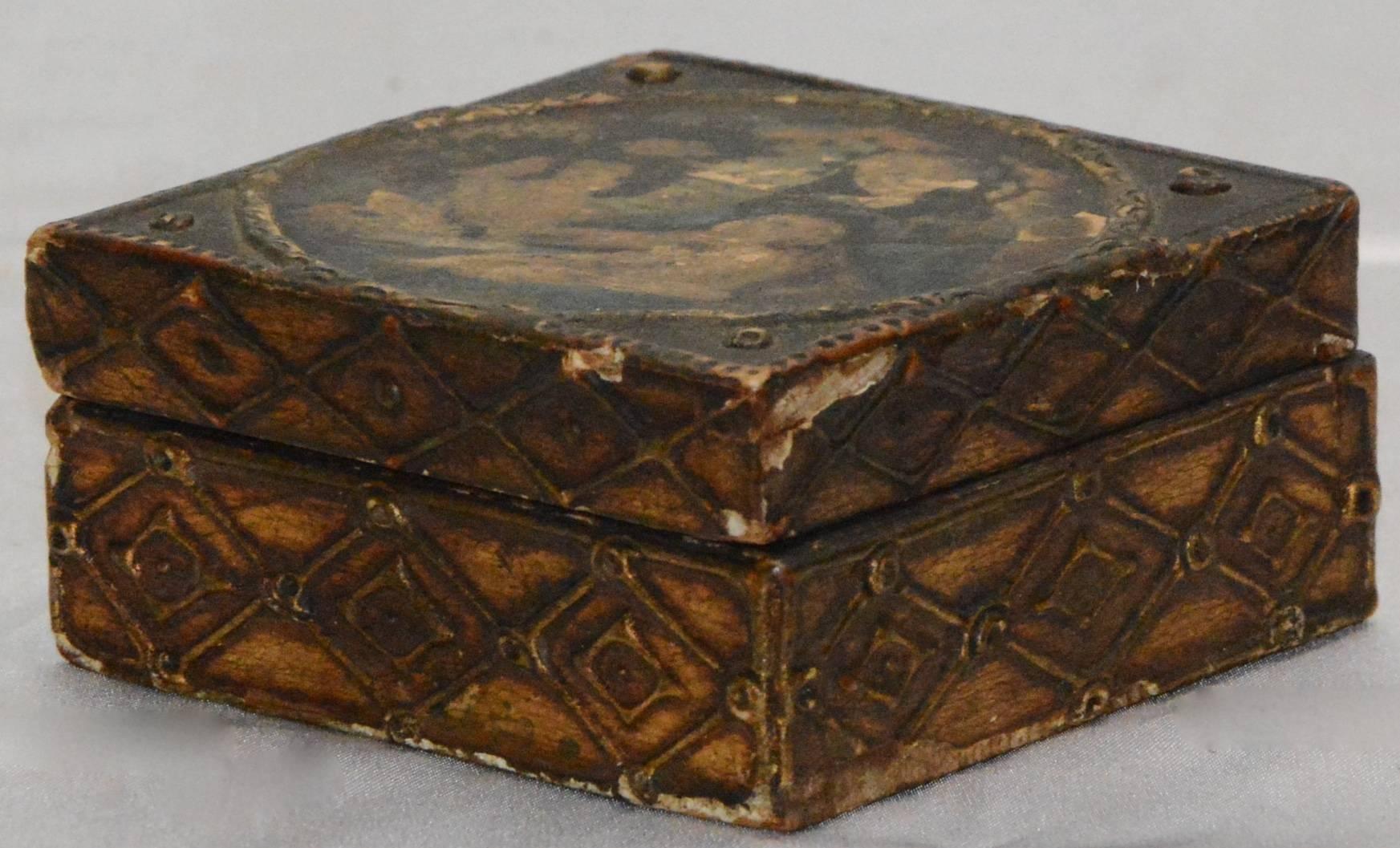 This is a fabulous wooden box is decorated with Madonna and child on the top. Adding to the elegance is the gilt finish on the sides featuring a diamond pattern.
The top opens up to unfinished wood.
