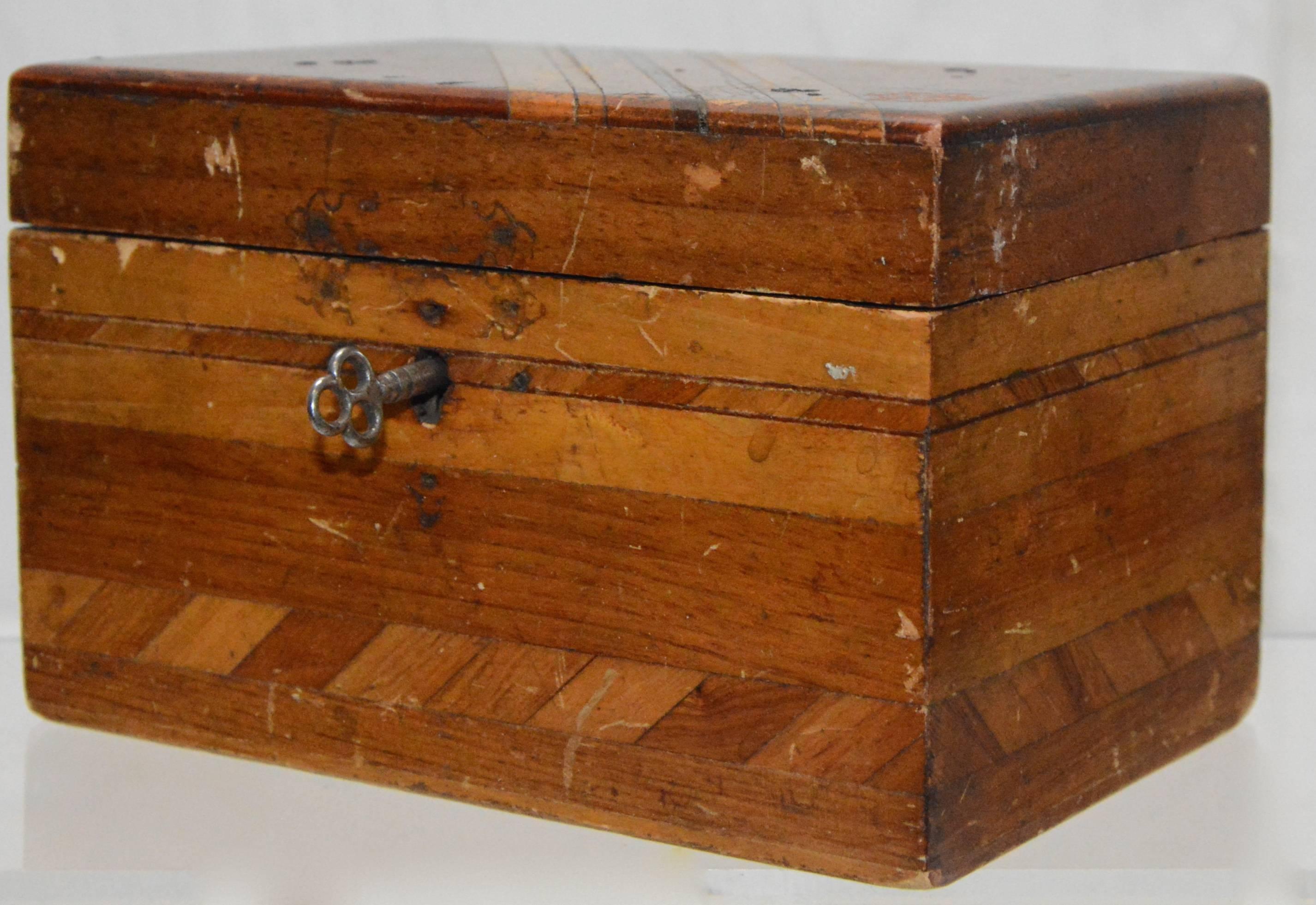 Geometric lines add to the beauty of this wooden box. The interior has a plush lining of rich blue velvet. There is a key to the box but it does not lock.