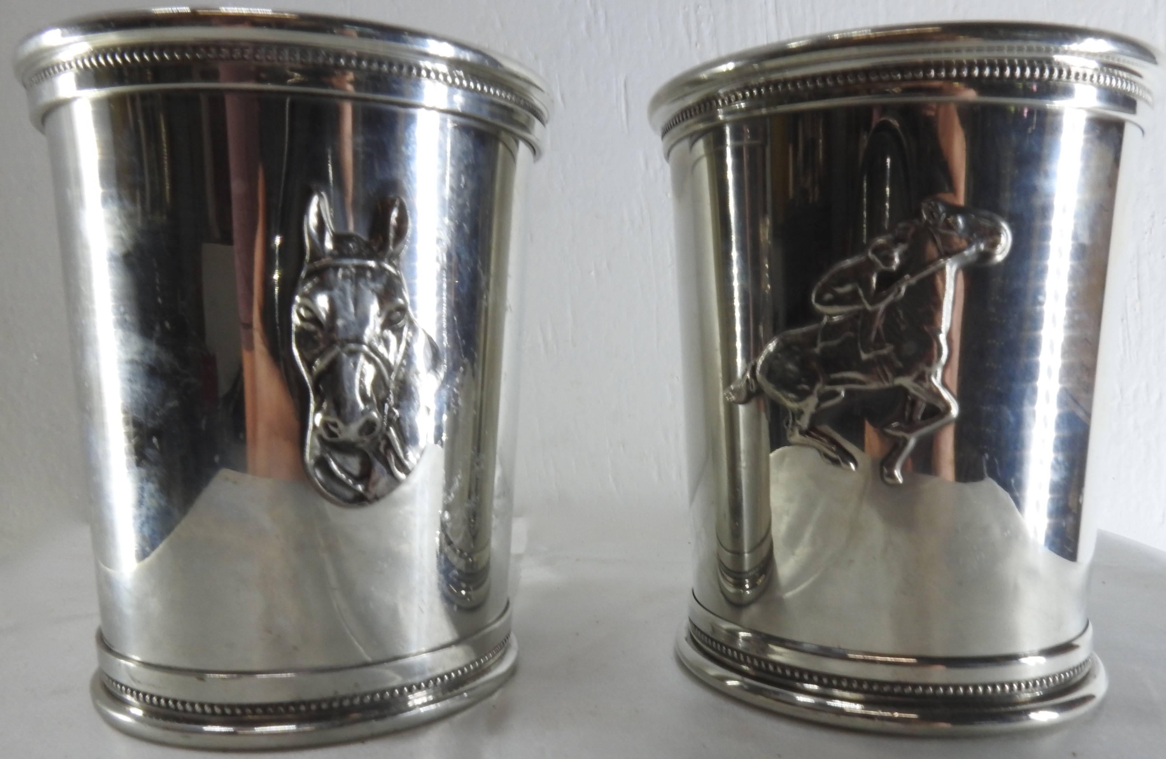 This is a nice pair of pewter mint julep cups featuring two different horse motifs. They are Governors Cups by Boardman. One of the cups features a jockey with a race horse and the other has a horse head. These are raised emblems on the cups.