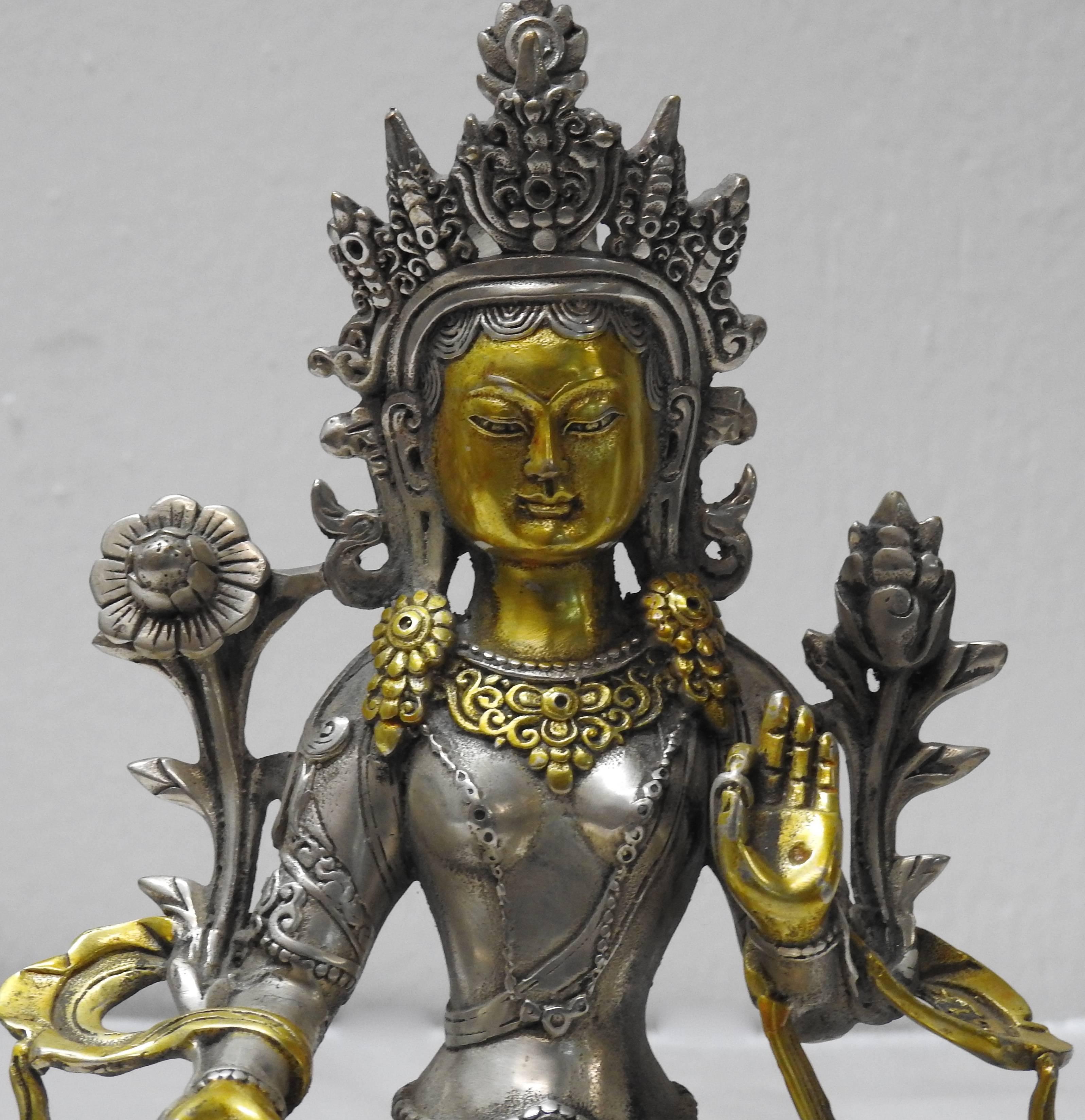 This is a brass with silver overlay Tara Goddess of Peace and Protection statue. Tara is known as the Buddhist savior-goddess of compassion who works to relieve human suffering. The present statue depicts her wearing an elaborate head ornament and