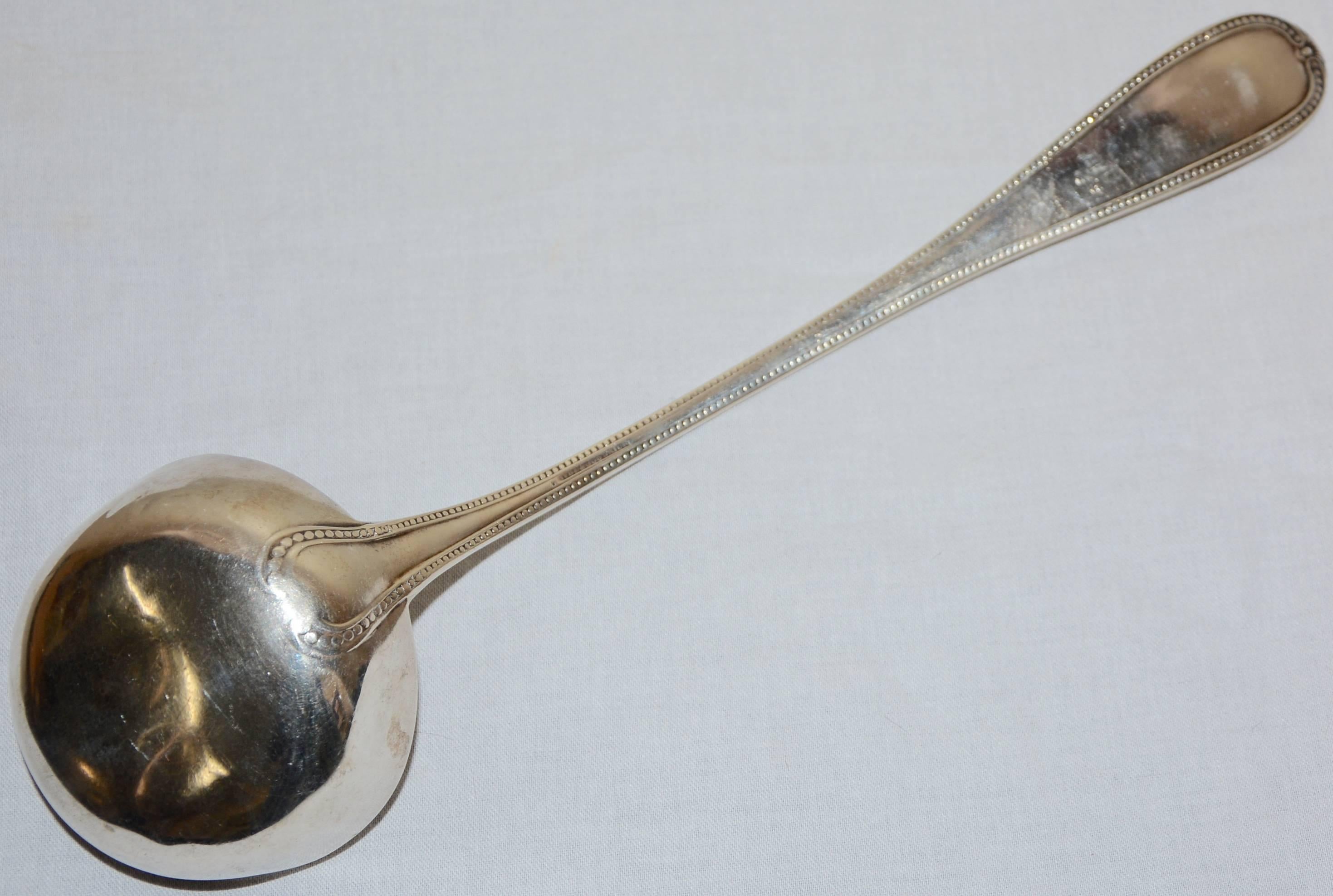 Featured is a Hyde Goodrich silver ladle, originally manufactured in New Orleans in the mid-19th century. It is enhanced with a border of dots and the handle is engraved with 