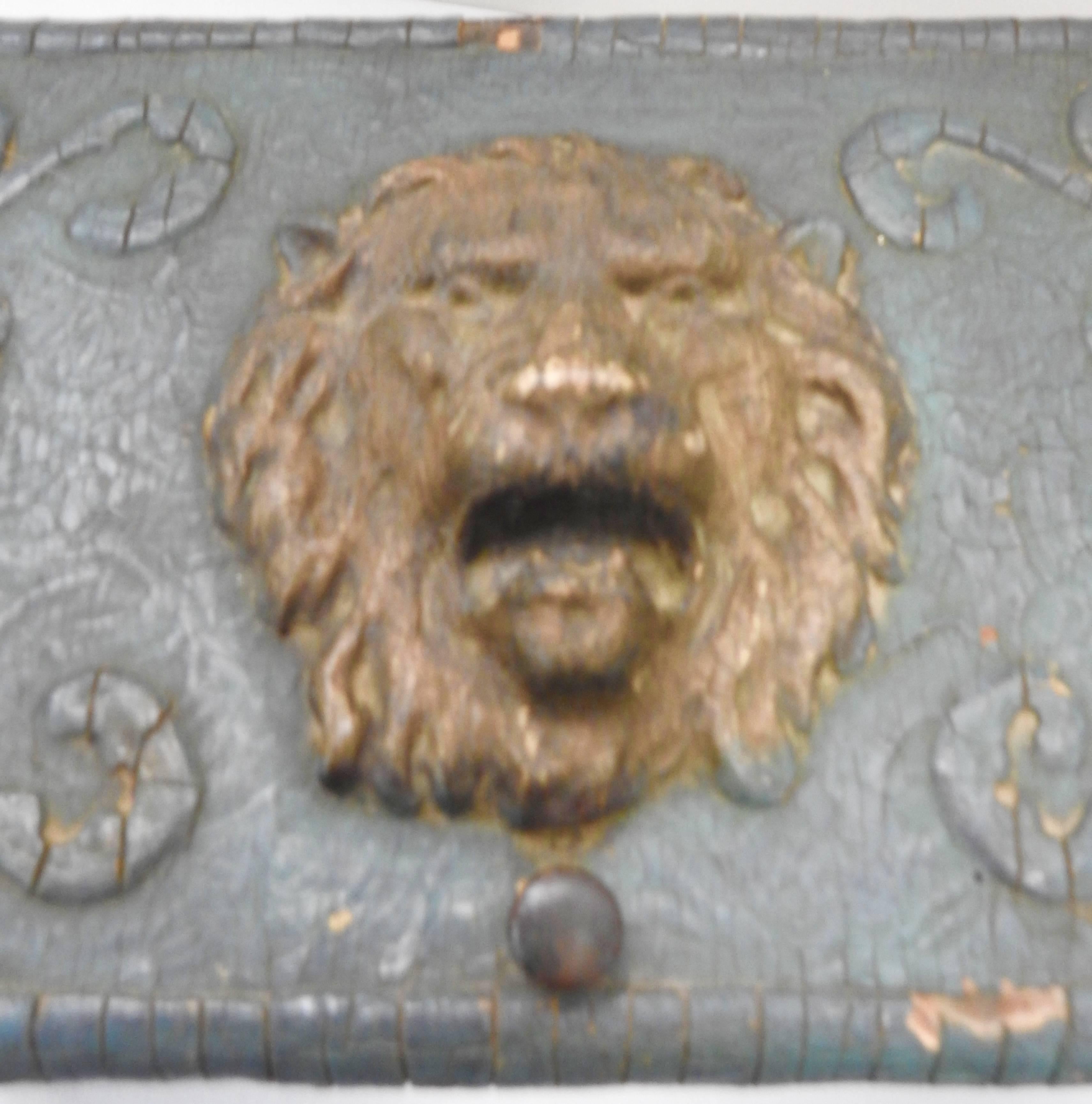 Dusky blue compliments the swirls on this Art Nouveau wooden box which is crowned on top with a roaring lion head. The top opens to swirls of antique gold paint and a chain to support the lid. There is a lock but a key is not available.