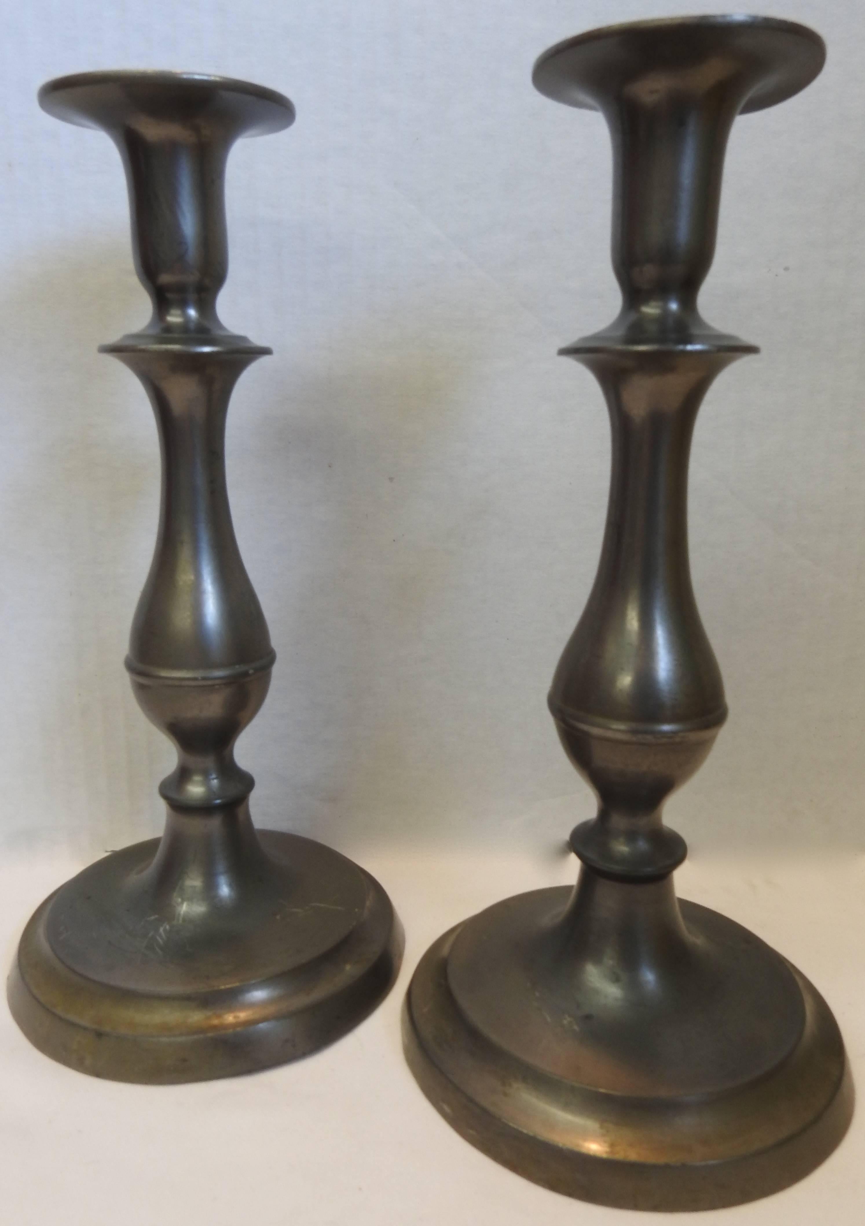 These are Classic Colonial style tall candlesticks to add beauty to your surroundings. The graceful lines take you back to yesteryear. Solid Pewter that has aged to a beautiful patina.