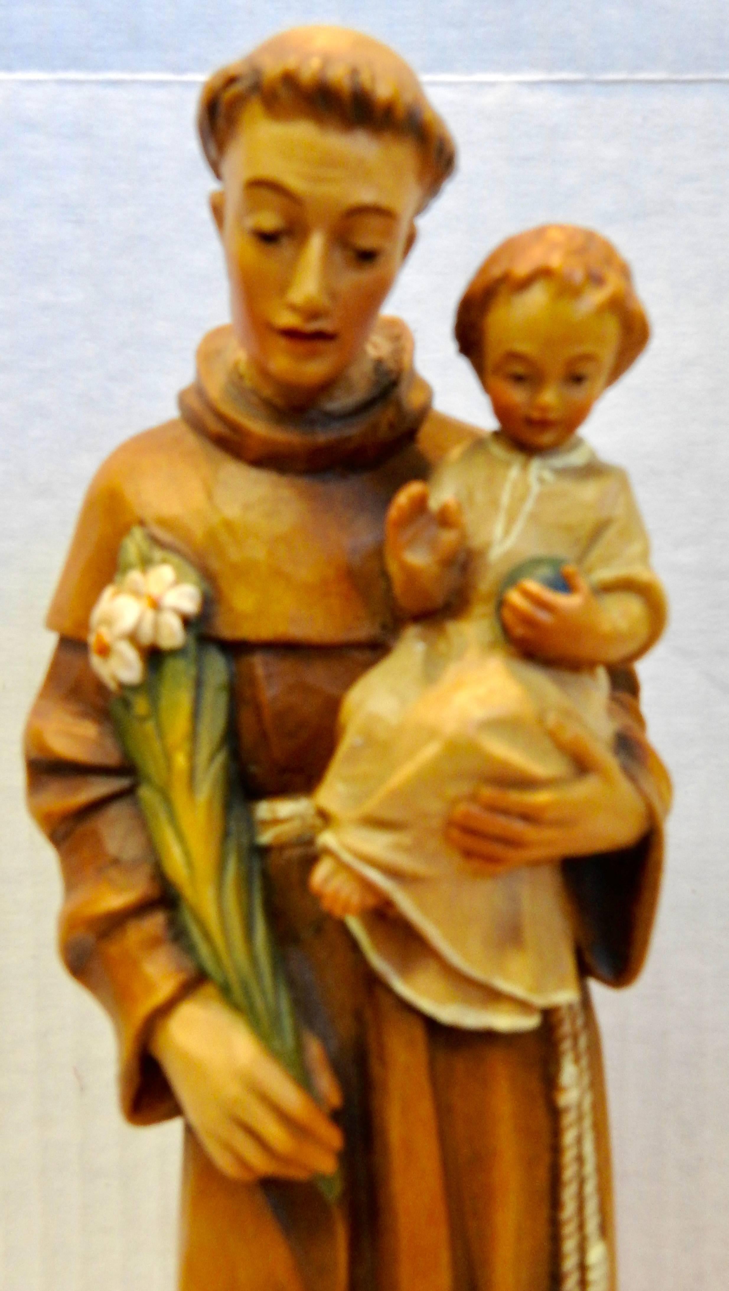 The faces on this hand carved figurine will make you love them. St. Anthony is holding the Christ Child and stems of flowers. It is painted is soft colors to add to the beautiful details. The piece is marked on the bottom, ANRI and Italy.