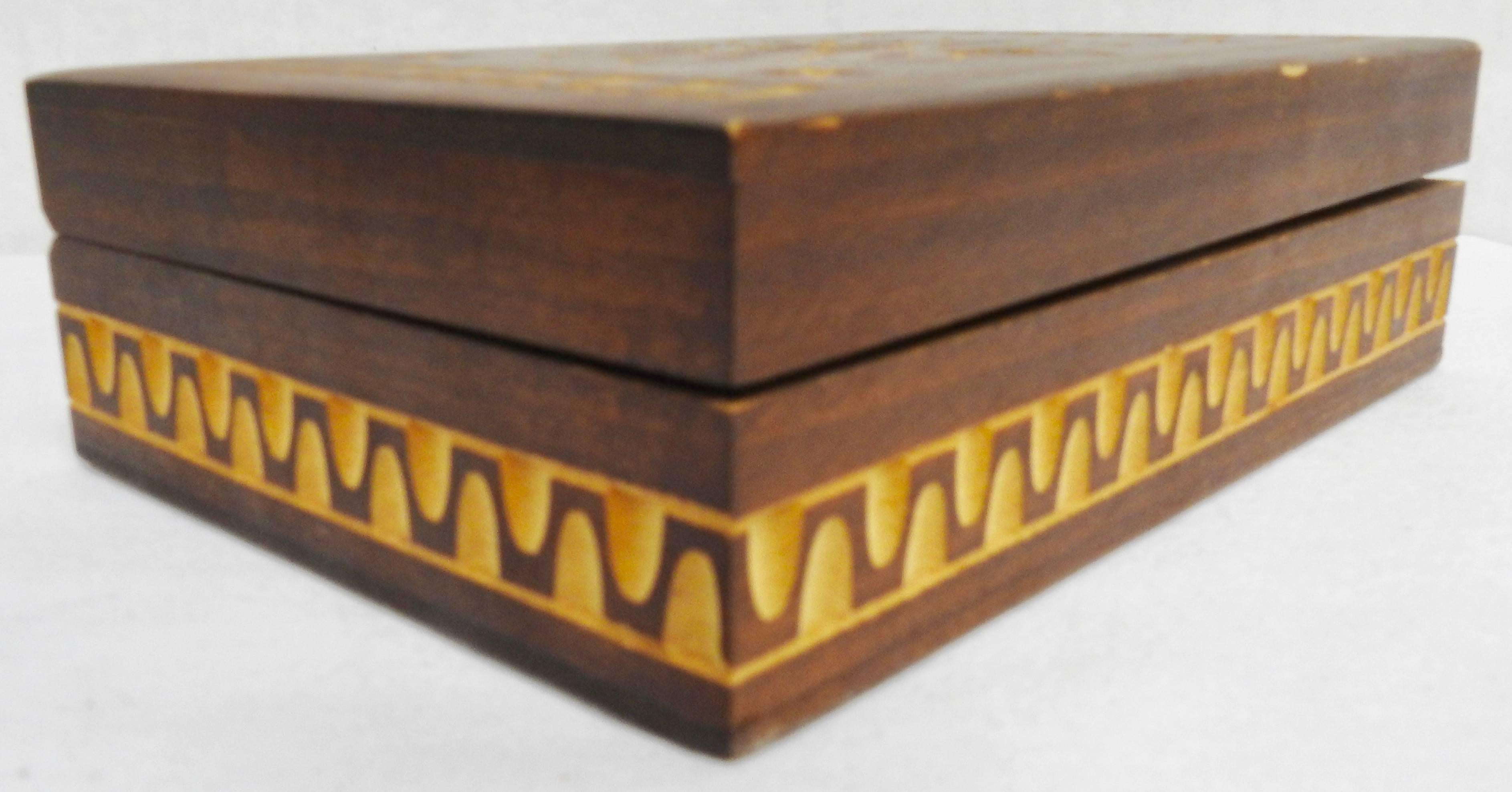 This vintage wooden box has been stained and beautiful carvings added to let the natural wood show through. The inside of the box is unfinished.