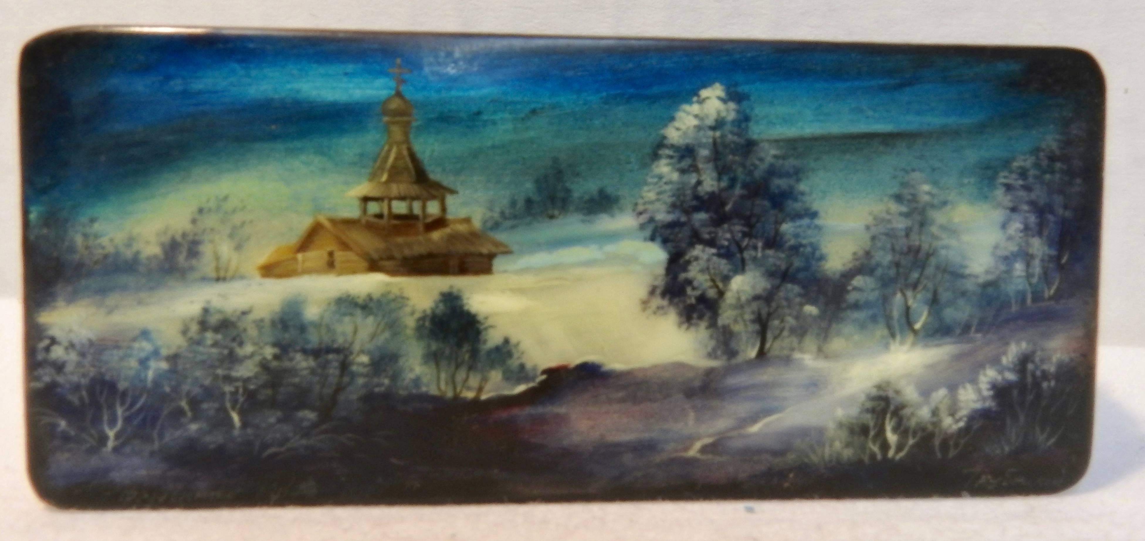 Beautiful shades of blue surround the mother-of-pearl snow scene on this black lacquer box from Russia. The lid opens to a vibrant shade of red. Dated 1937. It is signed but we could not distinguish the artists name.