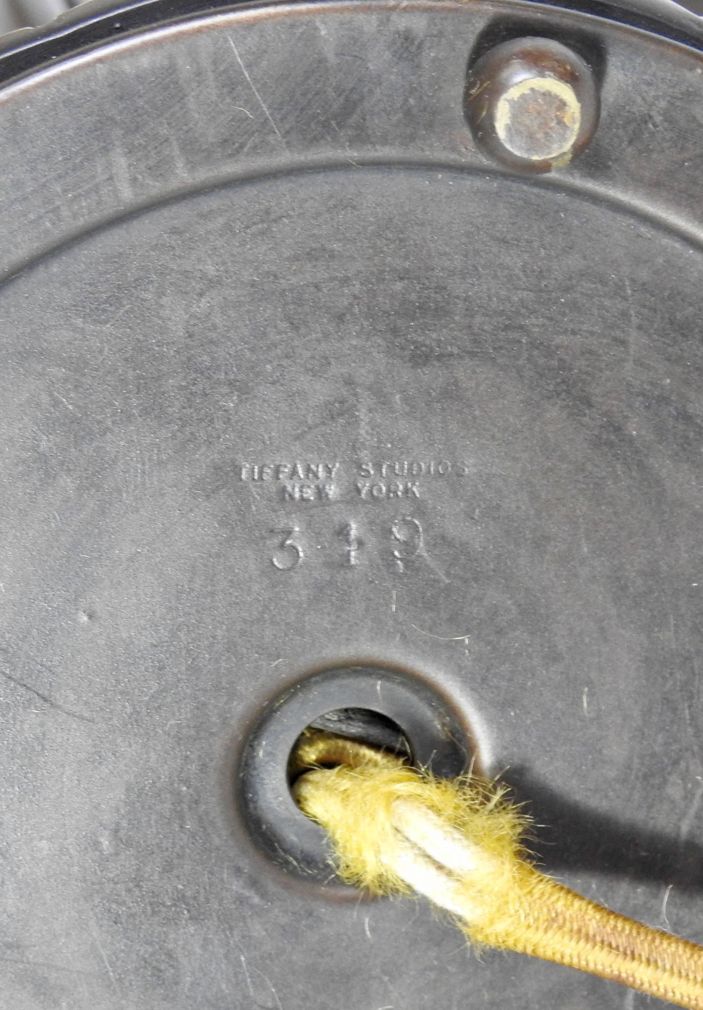 Stunning tiffany New York Art Nouveau lily table lamp with the original shades. Features three-arms with art glass shades. Marked on the base 