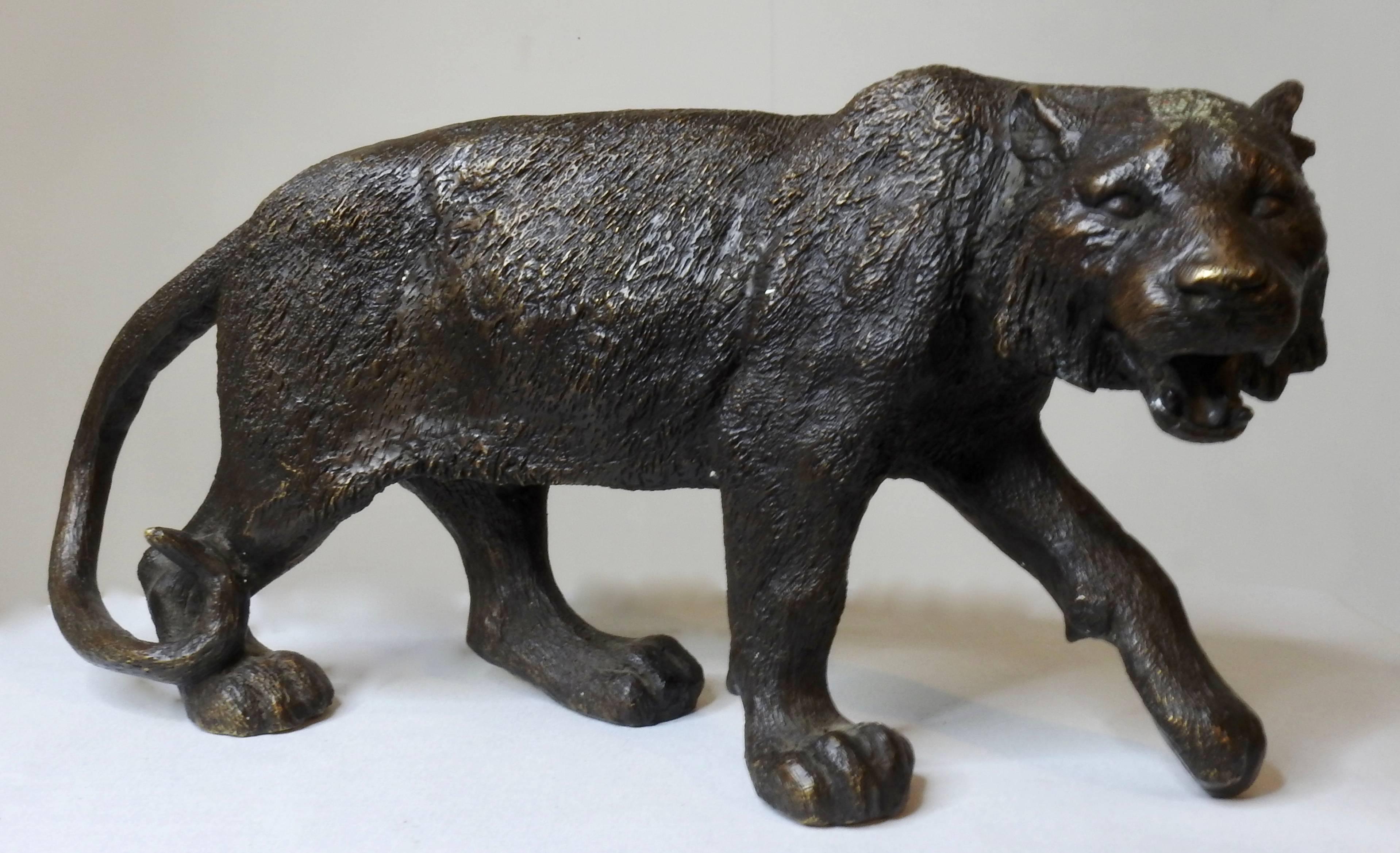 Art Nouveau bonze tiger has a beautiful aged patina. The detailing in the fur make this an extraordinary piece. It is in a prowling stance with a curled tail and mouth open.