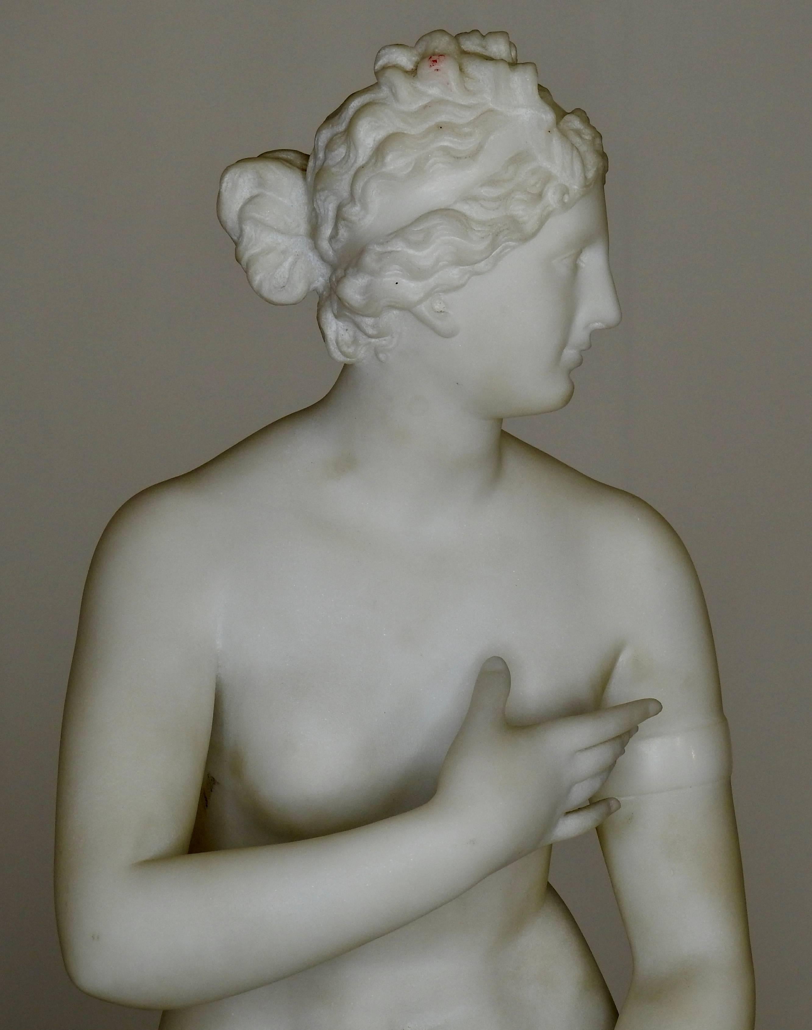 Graceful nude lady from the Art Nouveau era made of carved white marble. A pair of angelic cherubs ride a fish at her feet with a log poised behind her. Index finger on her left hand is broken off.