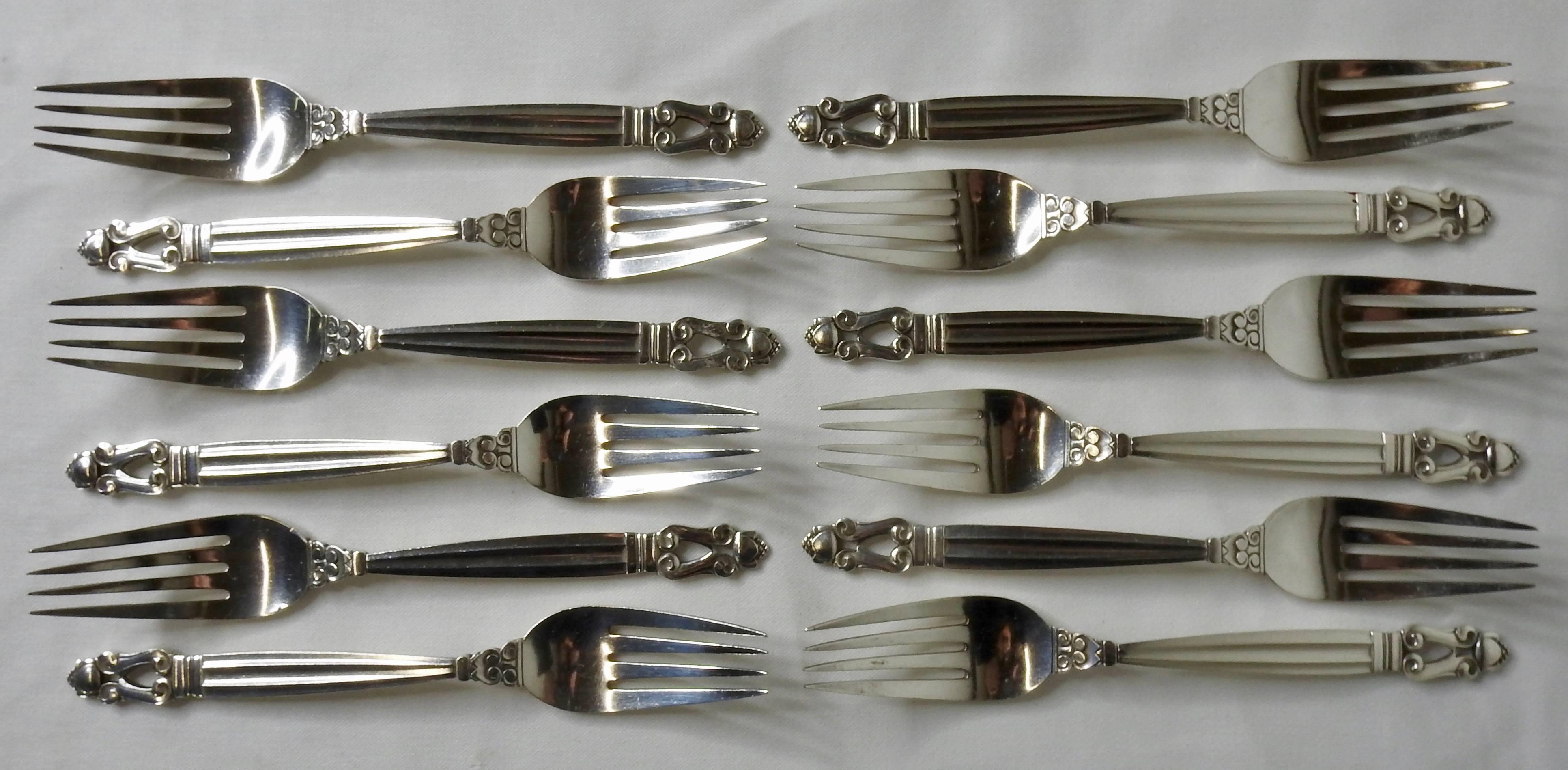 We are offering a Georg Jensen Acorn sterling silver flatware consisting of service for 12 with a total of 72 pieces. The set includes dinner forks, salad forks, knives, teaspoons, iced tea spoons and tablespoons all in a wooden case lined in brown
