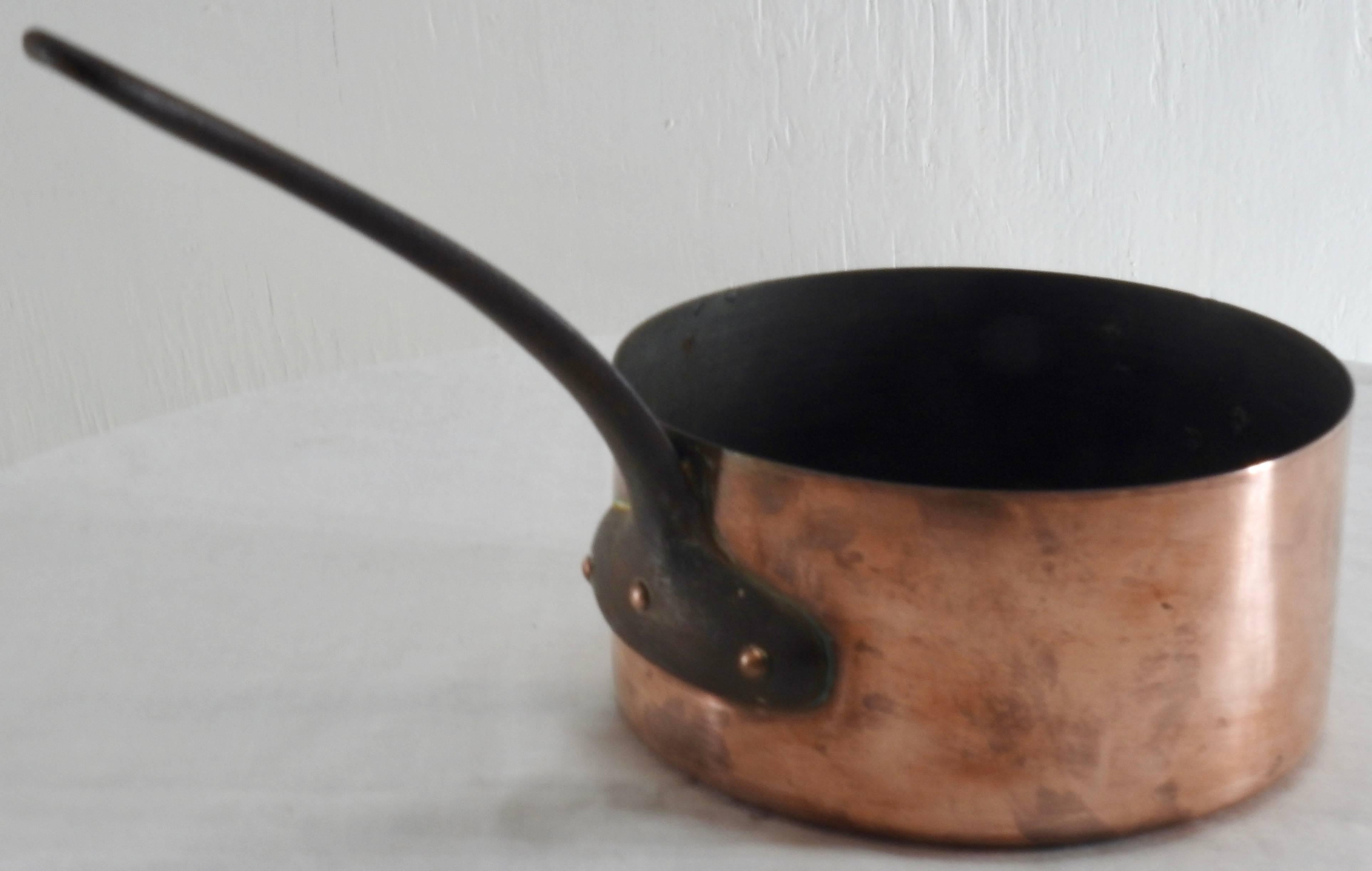 French small copper stock pan from France. Hand forged with a cast iron handle. Very heavy with a nice aged patina.

Measures: Handle length 6.75.