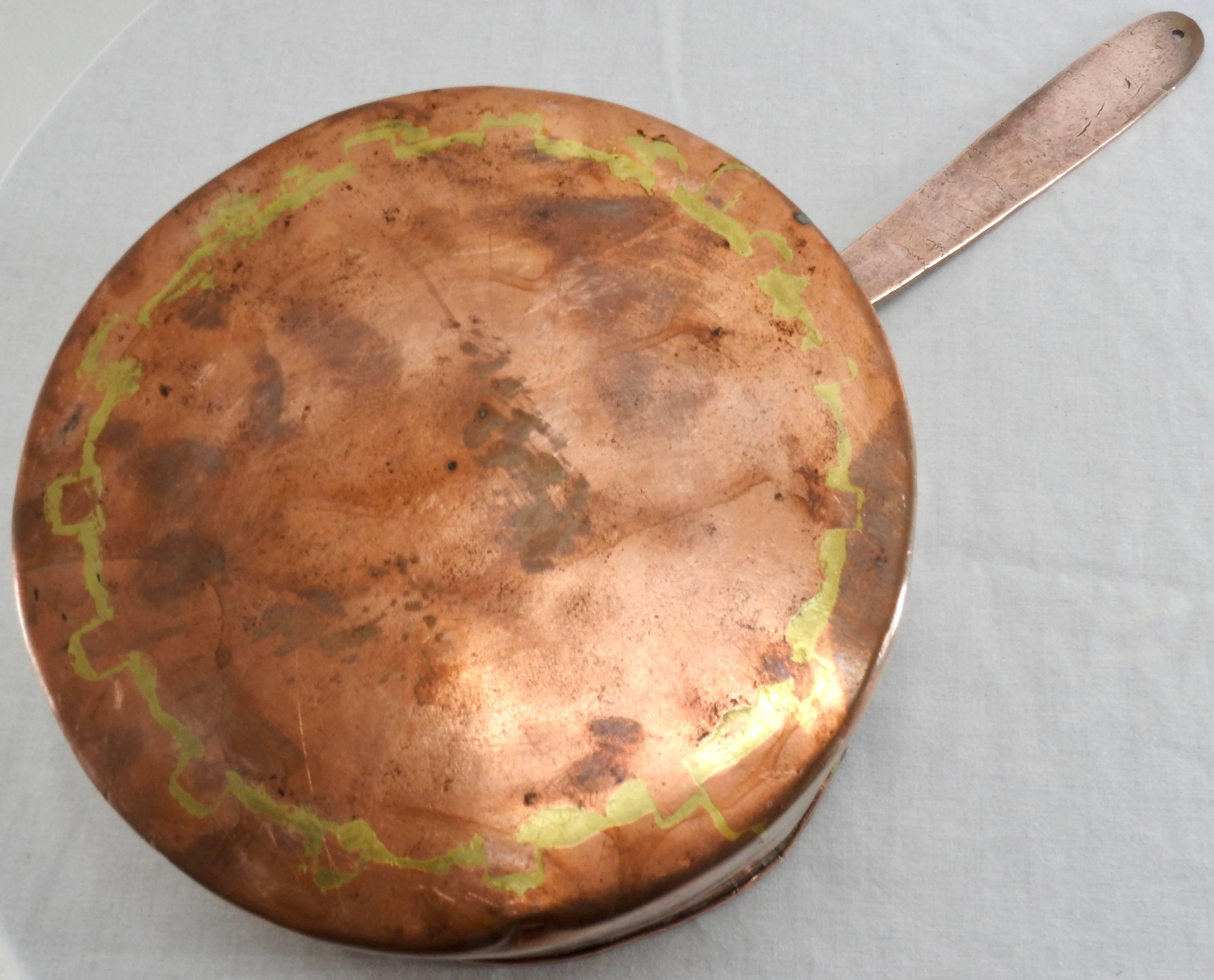 Medium size copper stock pan from France. Hand forged with dove tailing. Very heavy with a nice aged patina. Has the no. 11 on the bottom side of the handle.

Measures: Handle length 9.75.