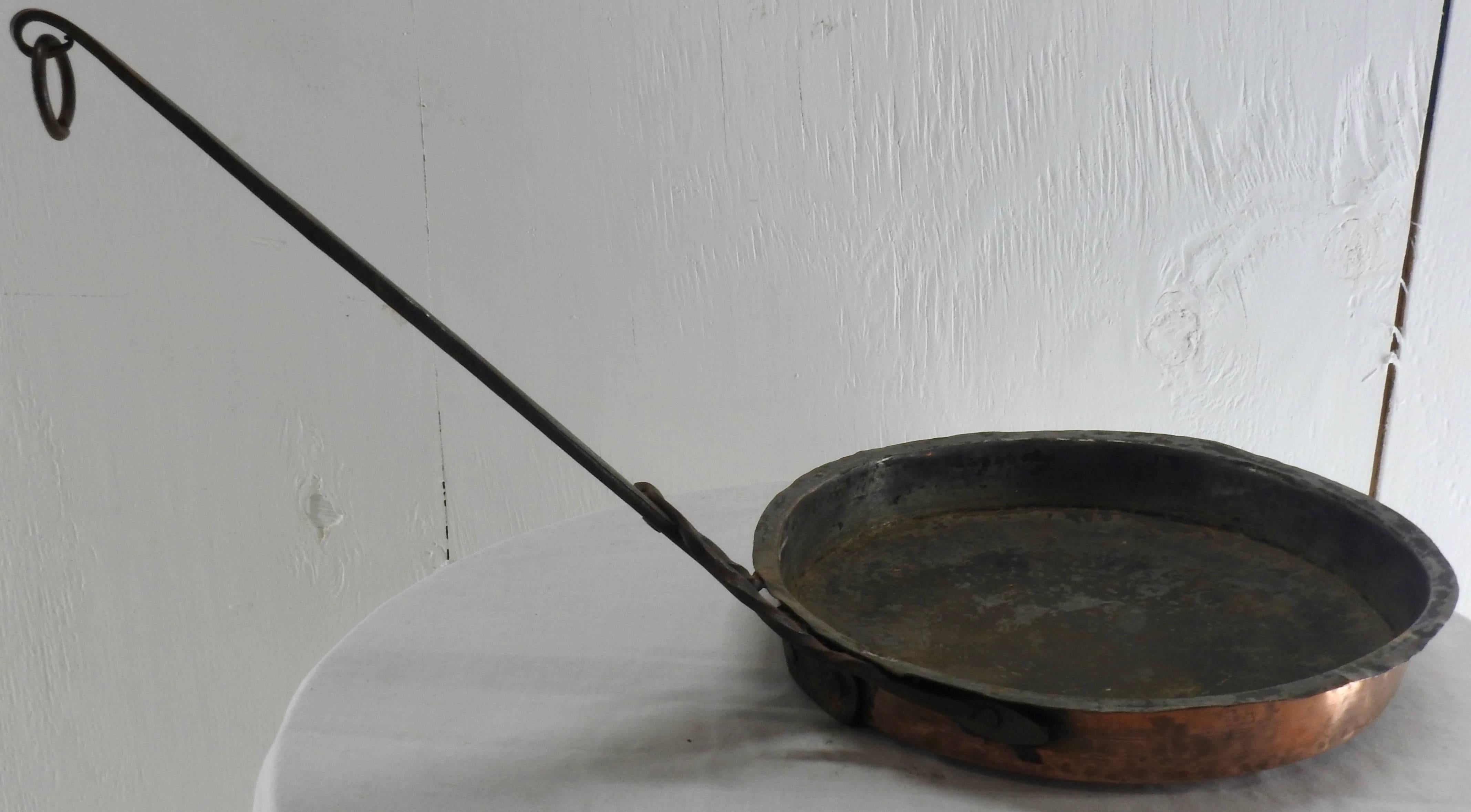 French jelly pan from France. Hand forged with a cast iron handle that has superb details. Loop on the long handle. Very heavy with a nice aged patina. 

Measures: Handle length 14.75.