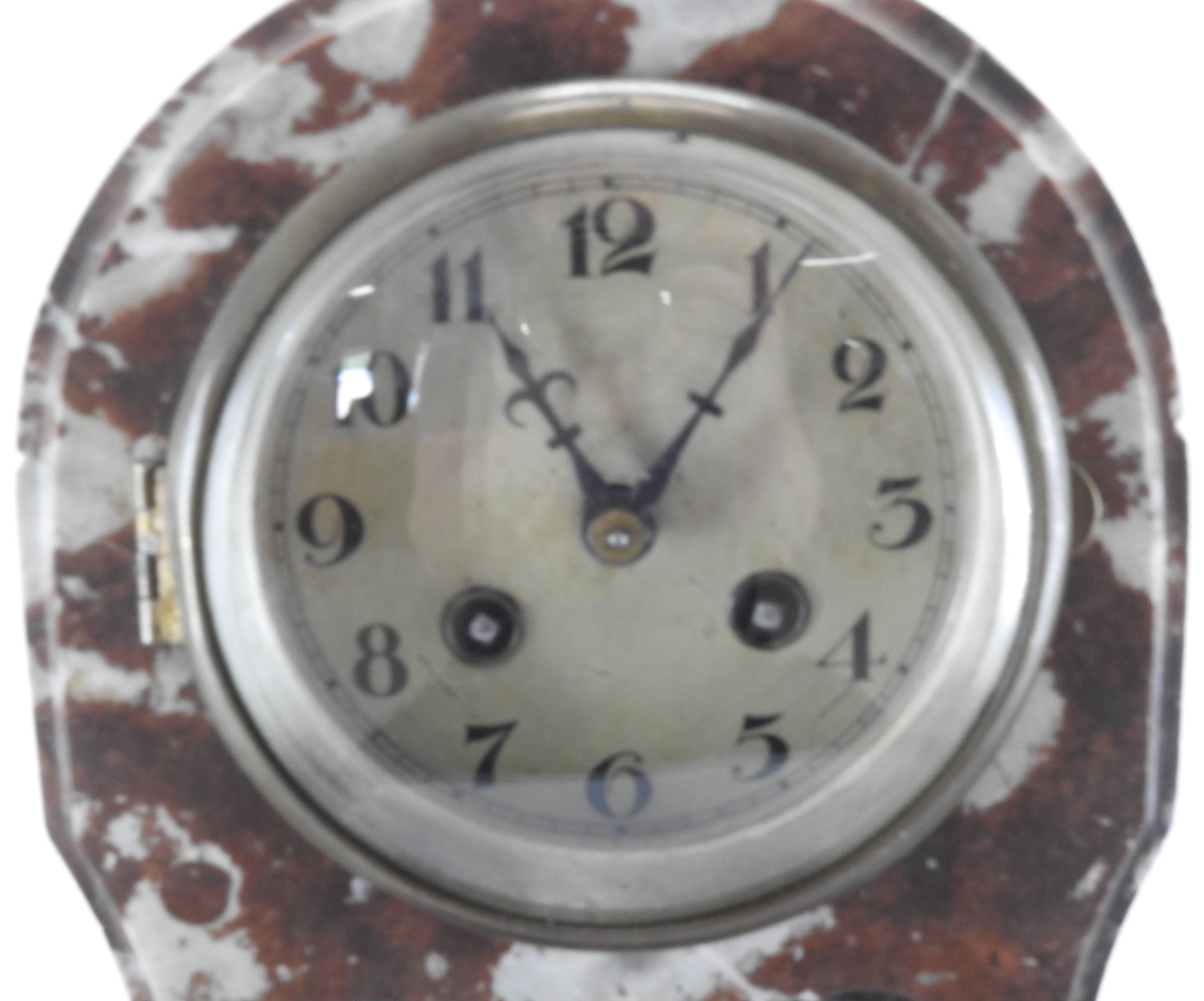 Lovely brown and white marble make up this matching set consisting of a clock and a pair of pedestals. The clear glass of the clock is enhanced with an etched floral design. The domed glass covers the metal clock face. The bronze hardware finishes