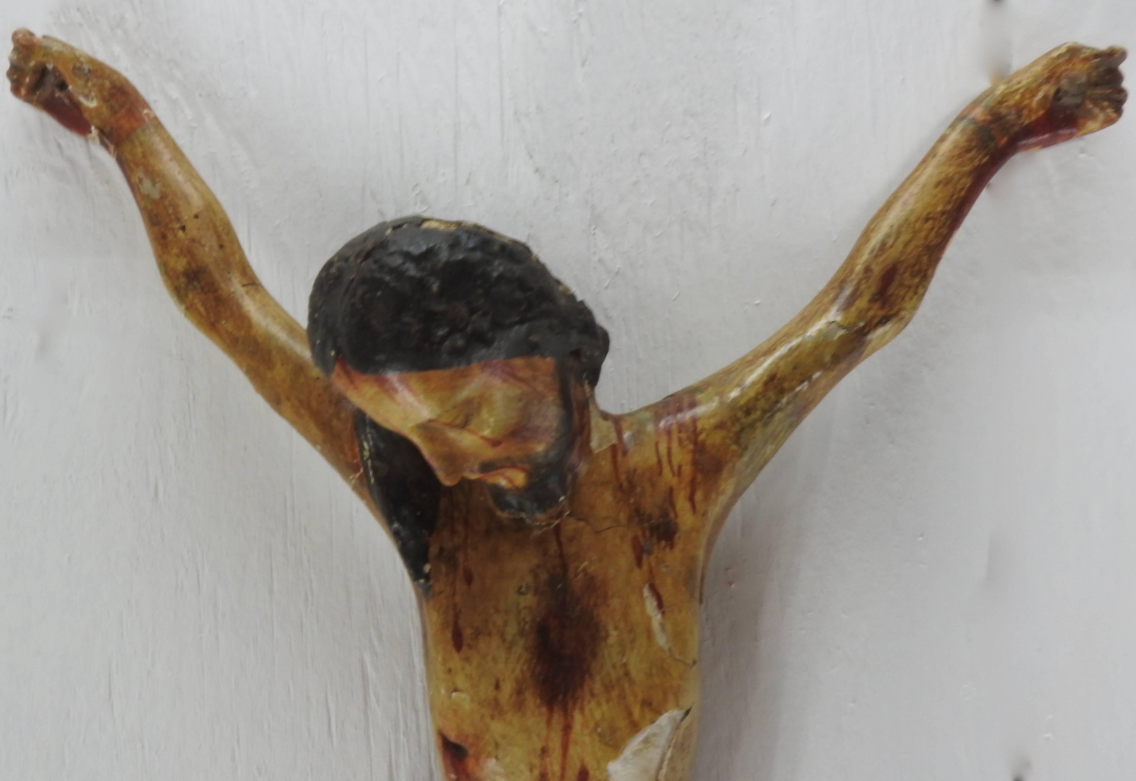 This is a rustic polychromed crucifix from Italy. Jesus is sadly hanging his head to the side. The soft colors add to the beauty of this piece. There is a wire inserted in the back for hanging on the wall.