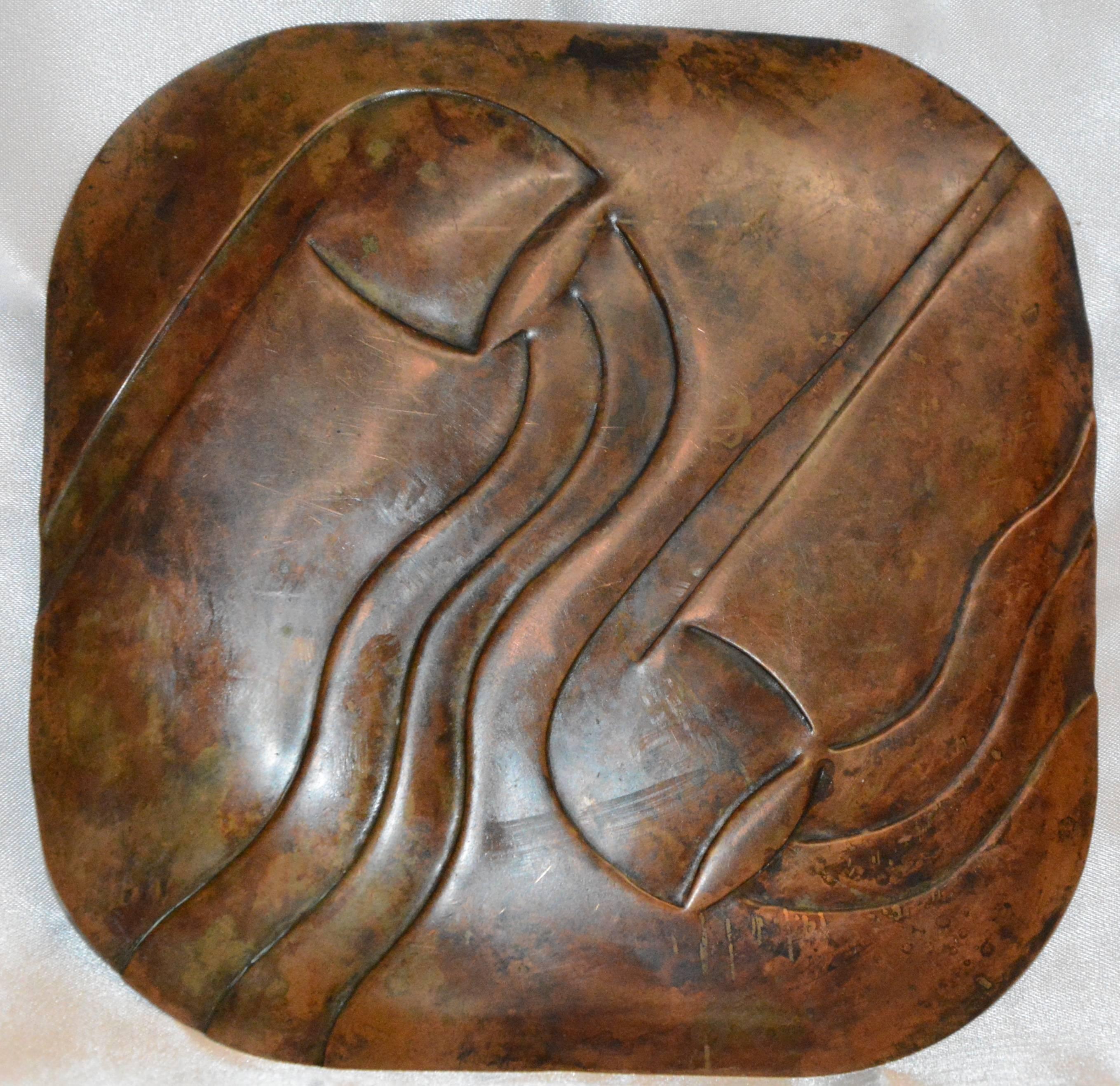 This is a unique piece of vintage artisan copper decor. Featured is a Francisco Rebajes midcentury copper tray with Art Deco inspired engraved pipe design. It is marked “Rebajes” to one edge. It has a beautiful, aged patina.