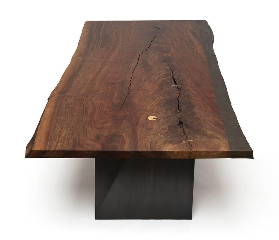 Handcrafted by Taylor Donsker in Northern California, the cast edge desk features a cast bronze live edge seamlessly attached to a single slab of highly figured Claro walnut. The wood grain textured cast bronze live edge maintains high levels of