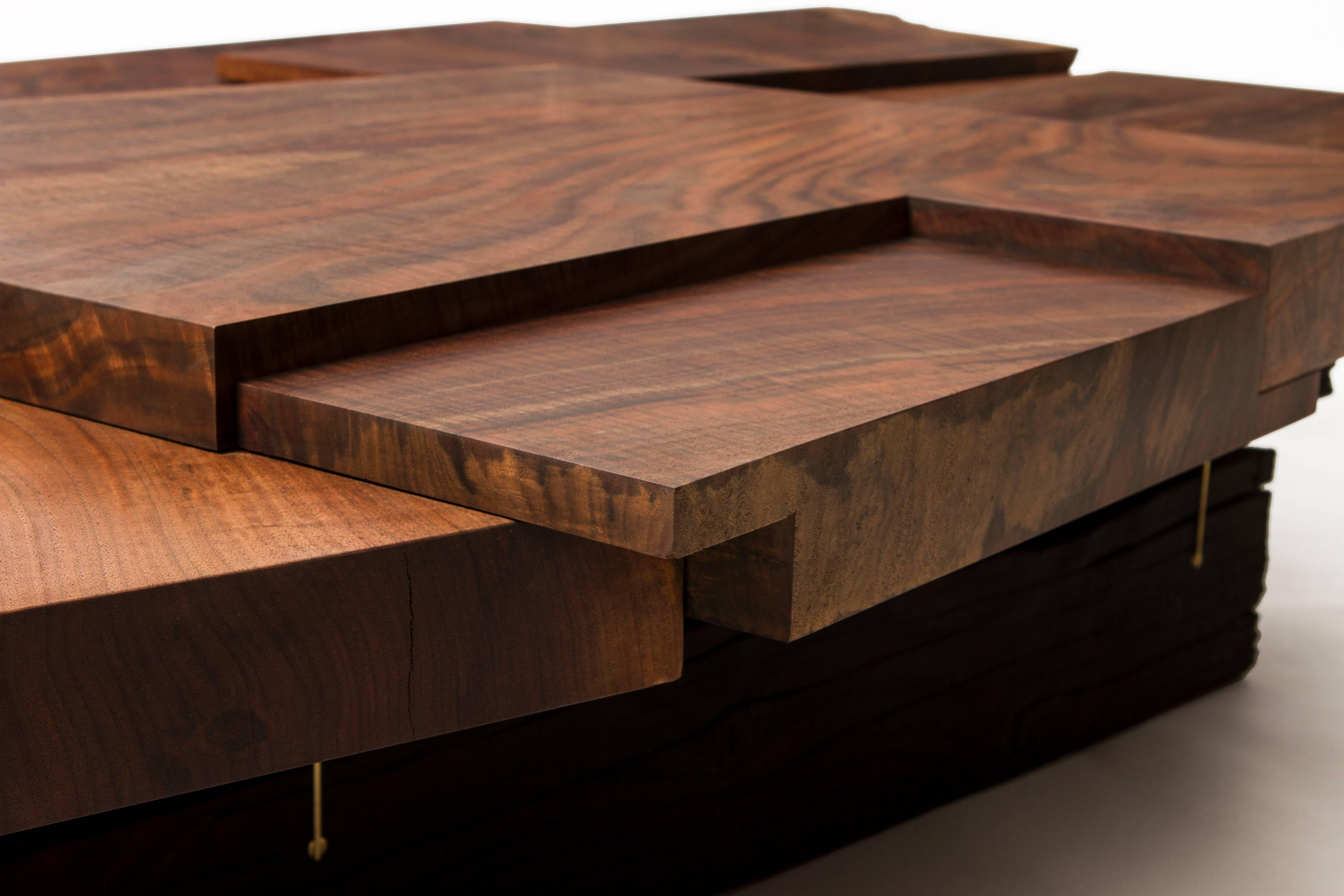 Handcrafted by Taylor Donsker in Northern California, this piece is inspired by strike slip earthquakes and wood movement. The Strike/Slip coffee table features a multi-layered, 'ruptured' surface with two independently supported halves. This allows