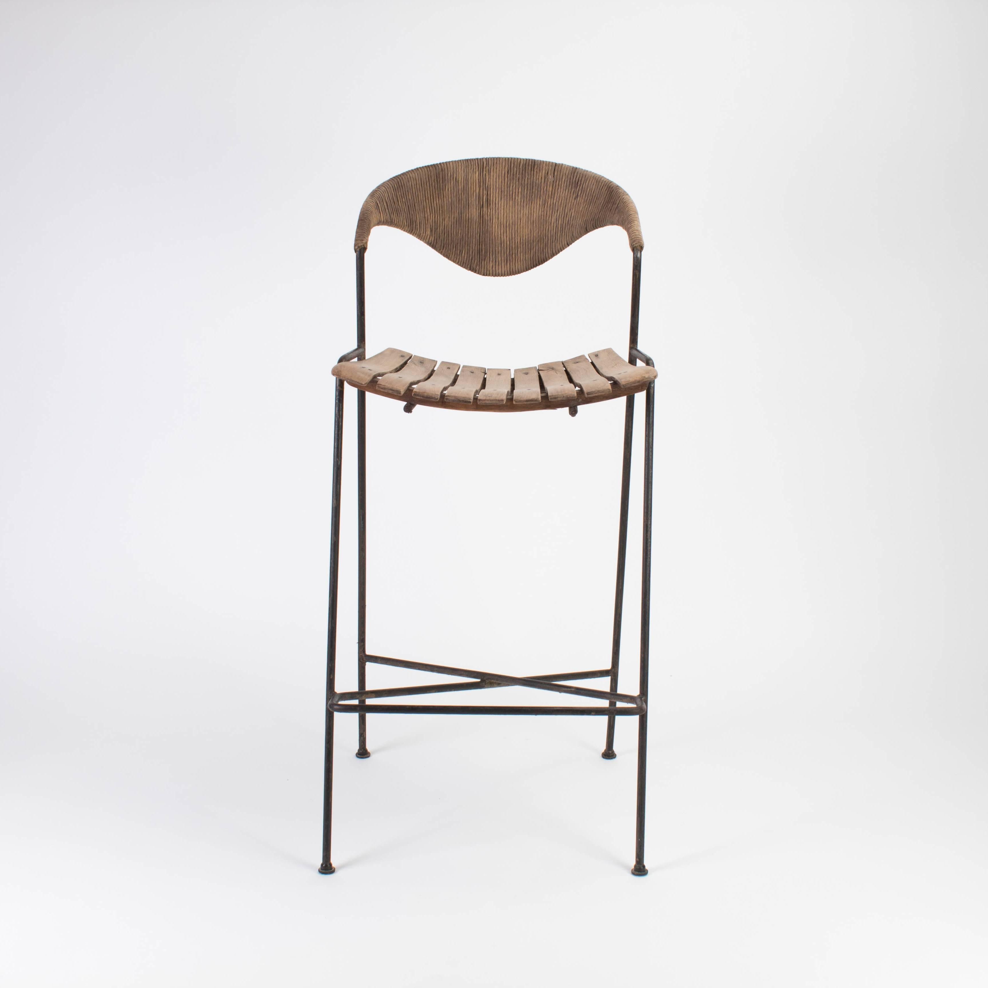 Mid-20th Century Arthur Umanoff bar stool with iron base with rushed back and wood slatted seats.