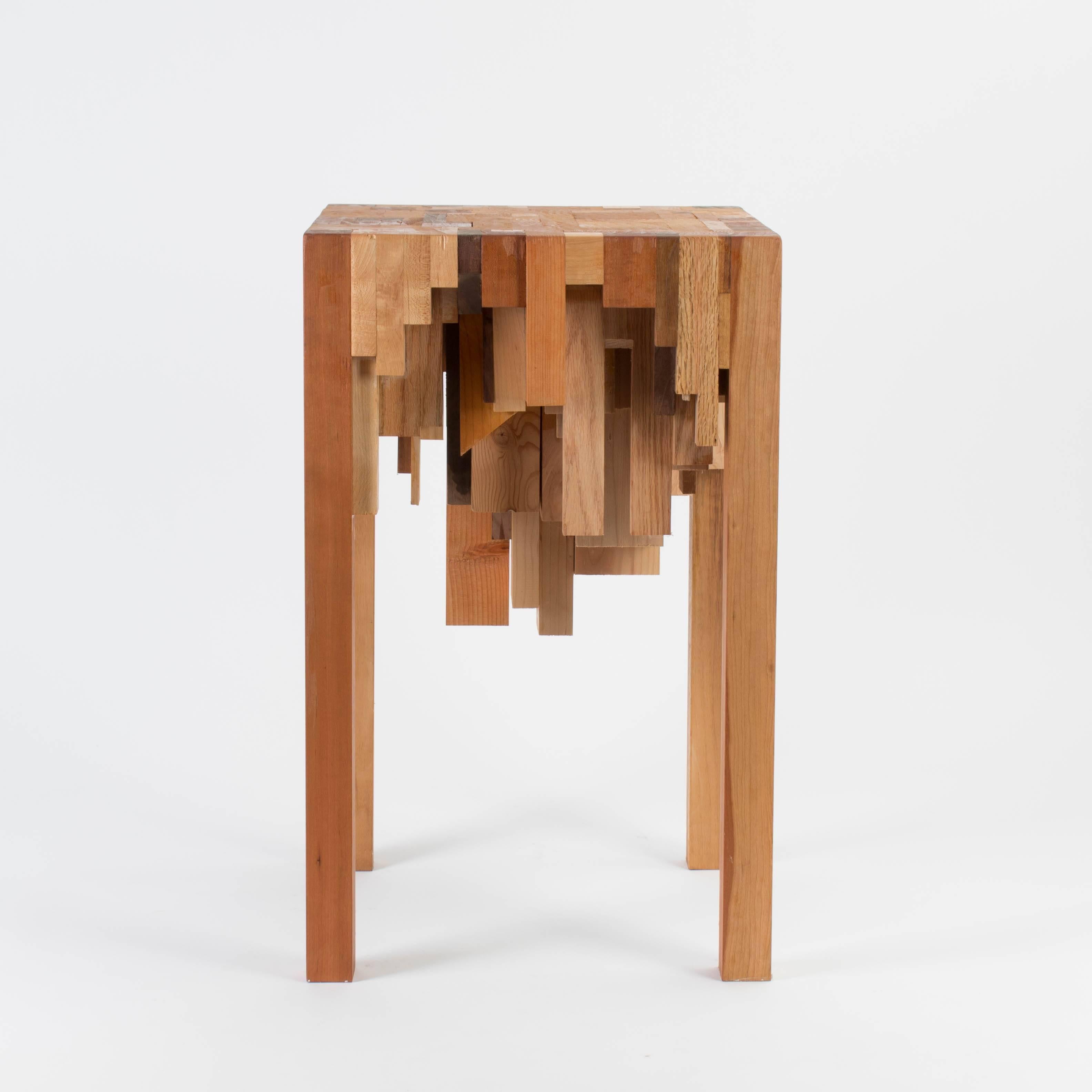Wooden pedestal made from different kinds of wood by a artist studio.
  