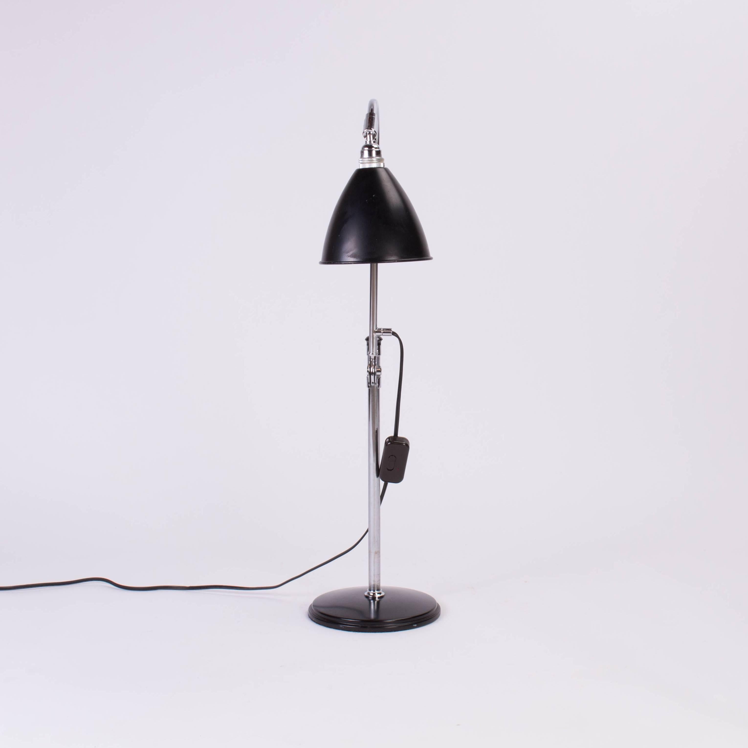 Industrial style desk lamp with adjustable height in chrome and lacquered metal.

Base 8 inches, low height 19.75 inches, tallest height 32.5 inches.