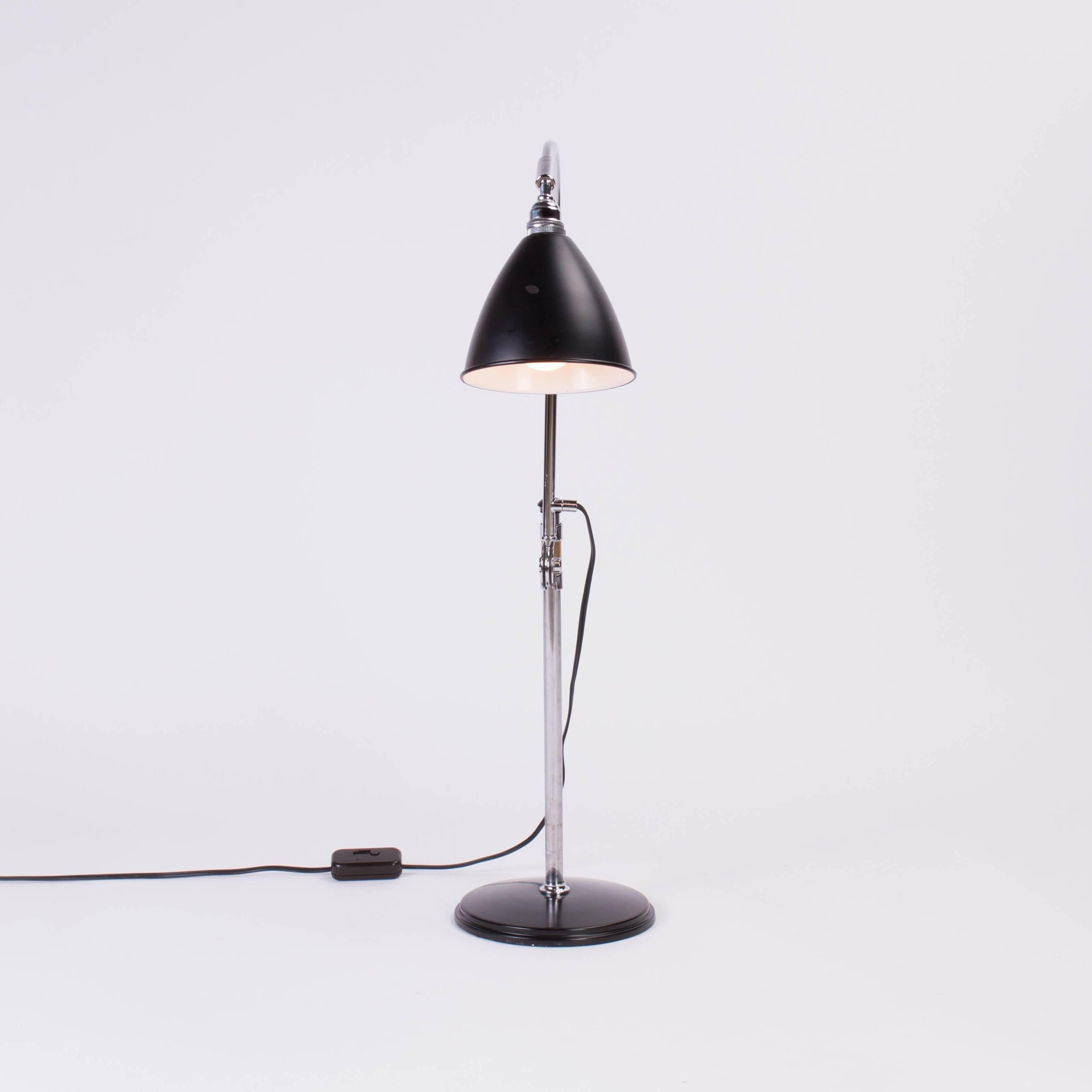 Industrial style desk lamp with adjustable height in chrome and lacquered metal.

Base 8 inches, low height 19.75 inches, tallest height 32.5 inches.