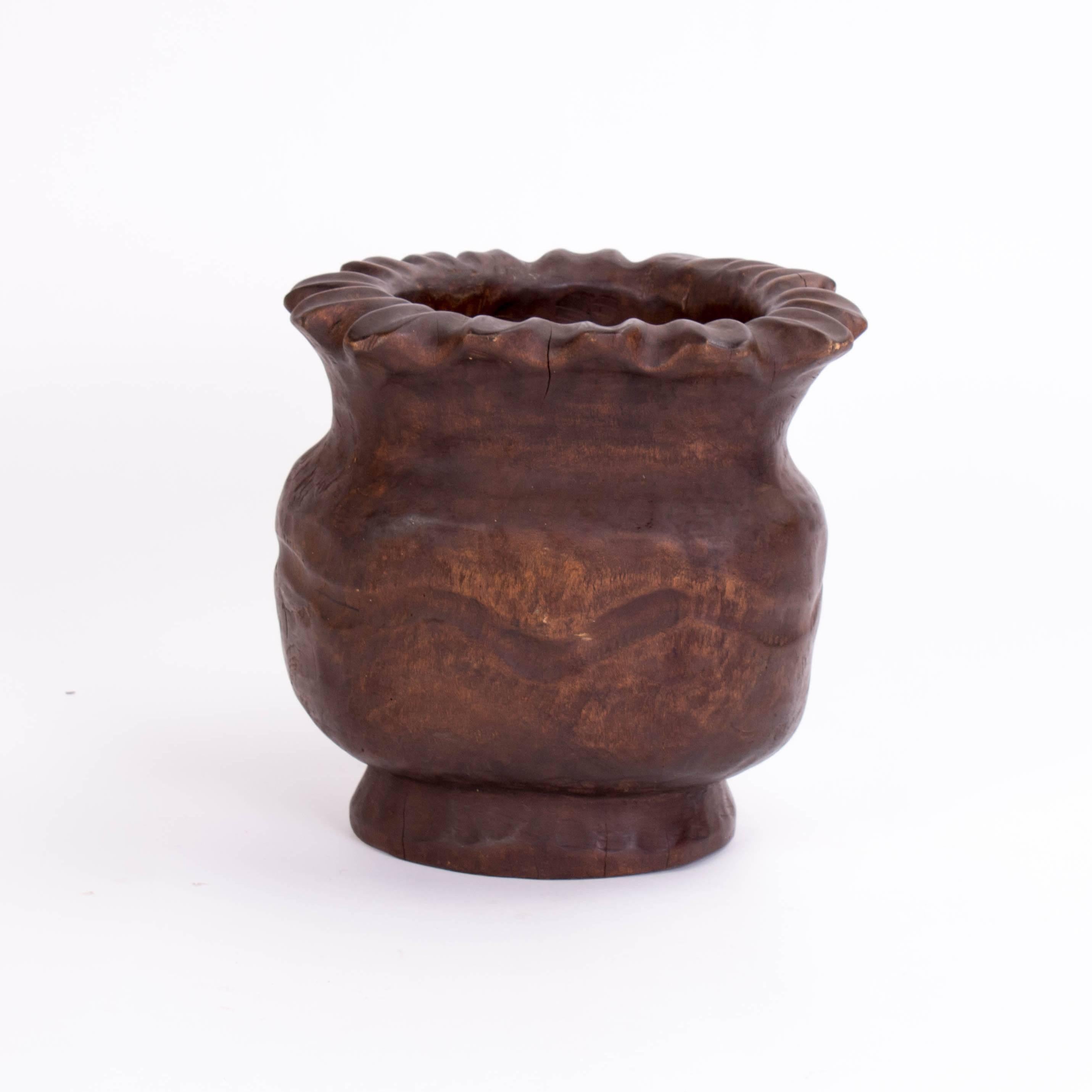 Wood carved poppy seed pod planter with small cracks on the base and the rim.