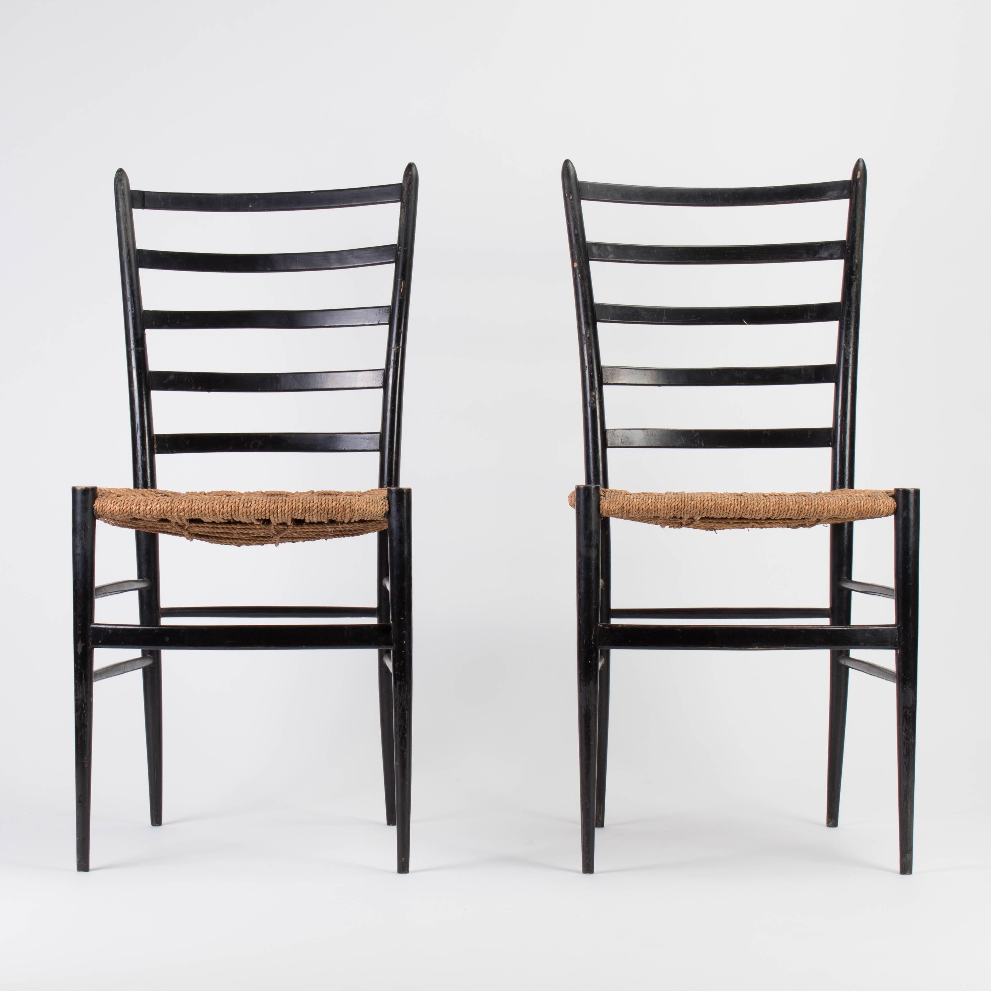 Two most likely Italian ladder back chairs in the style of Gio Ponti with rush woven style seats in black lacquer.