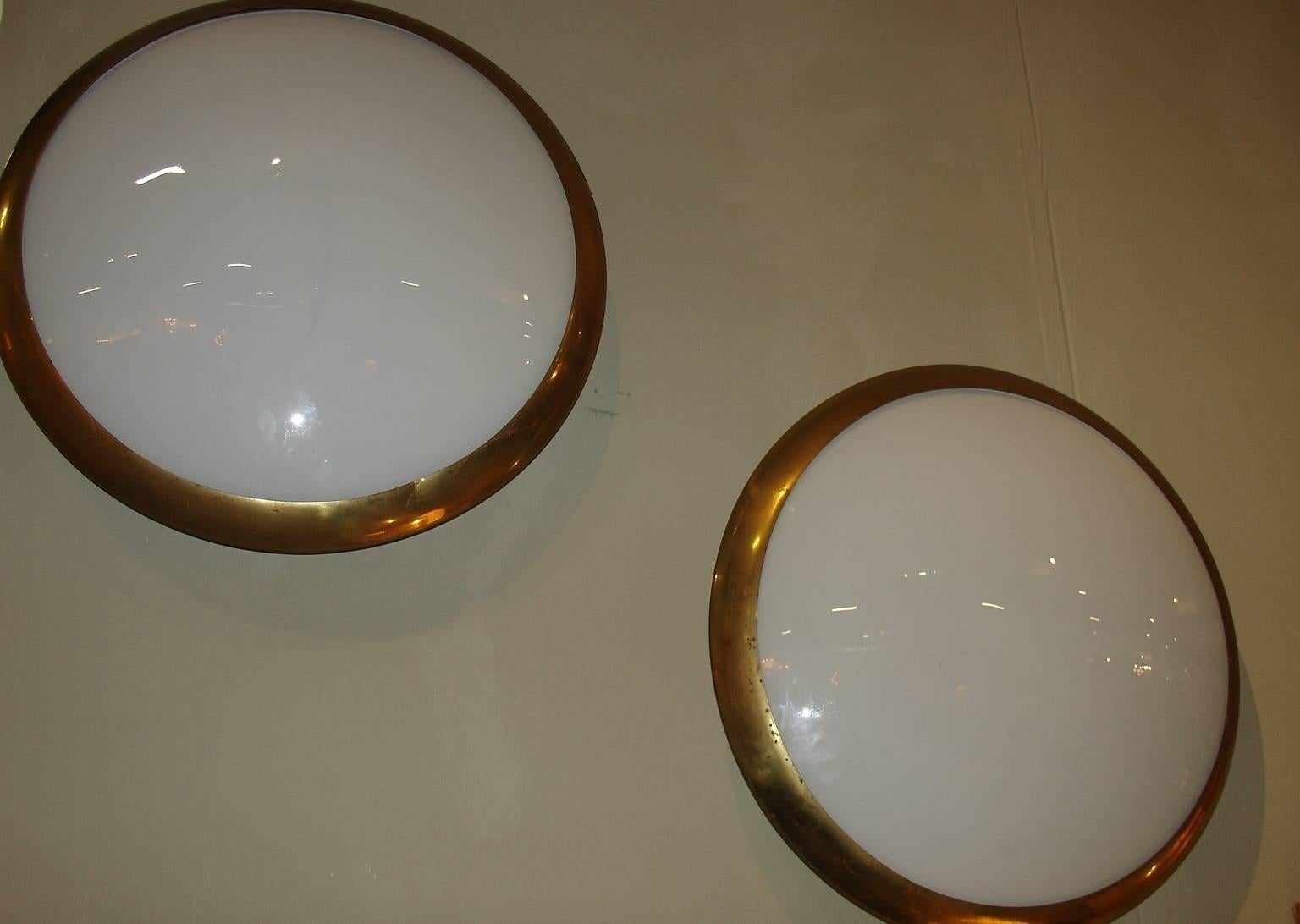 A pair of curved glazed glass and steel oxidised brass surround plafonniers/ceiling/wall lights designed by Fontana Arte referenced in the Fontana Arte book model 2262.
 Fontana Arte was founded in Milan in 1932 by Luigi Fontana and Gio Ponti and