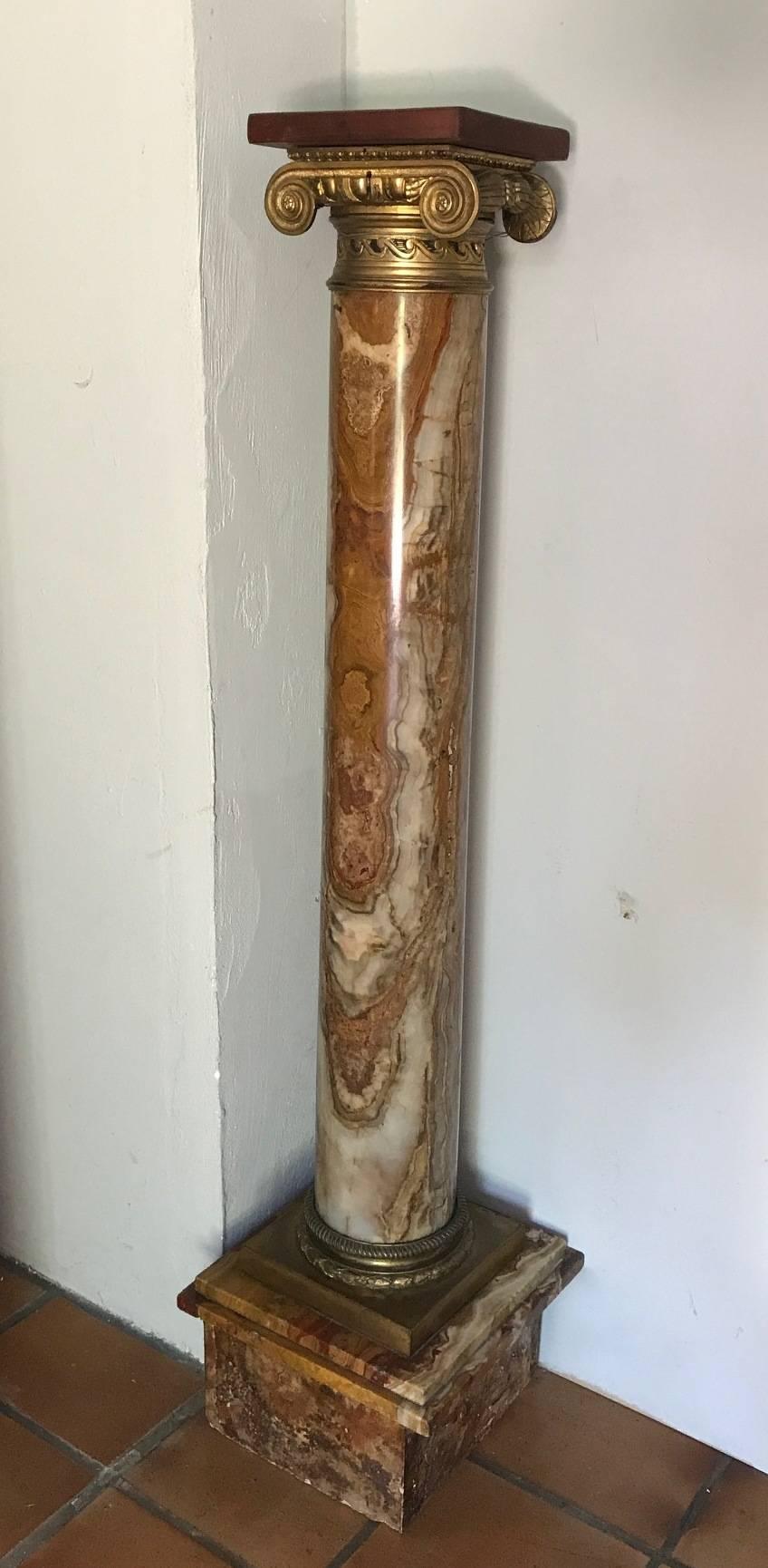 A beautiful breccia rouge royale marble and ormolu-mounted ionic pedestal column. Replaced wooden plinth.