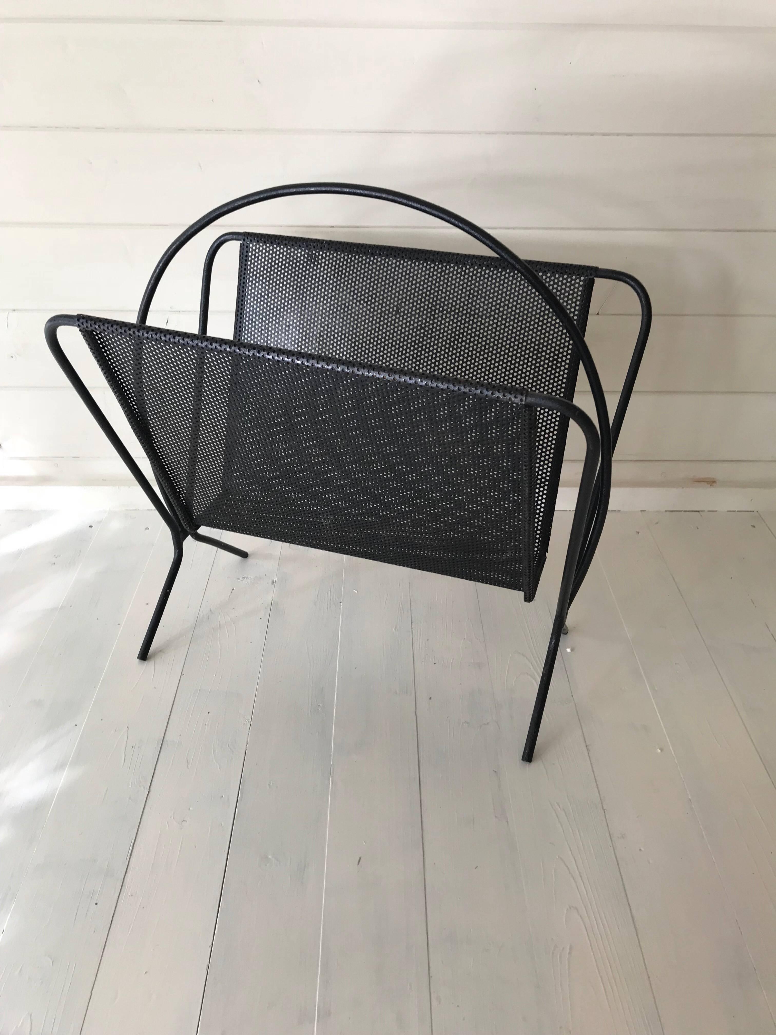 A large pierced metal black painted heavy magasine rack in the style of Matthieu Mategot, French, circa 1955.