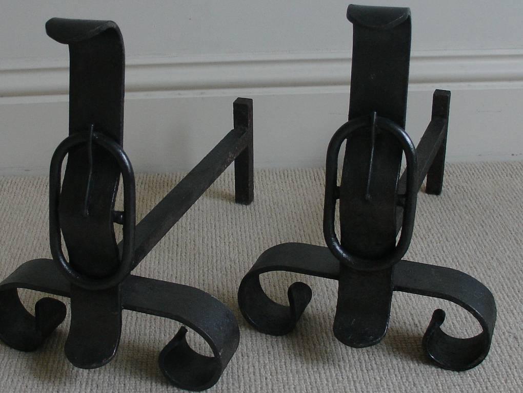 A pair of well-designed French wrought iron andirons or firedogs. Interesting buckle detail, circa 1950s.
