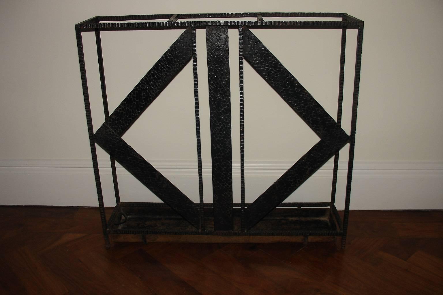 An elegant modernist, Art Deco French umbrella stick Stand in the style of Raymond Subes. Hammererd wrought iron with removal tray, circa 1930s.