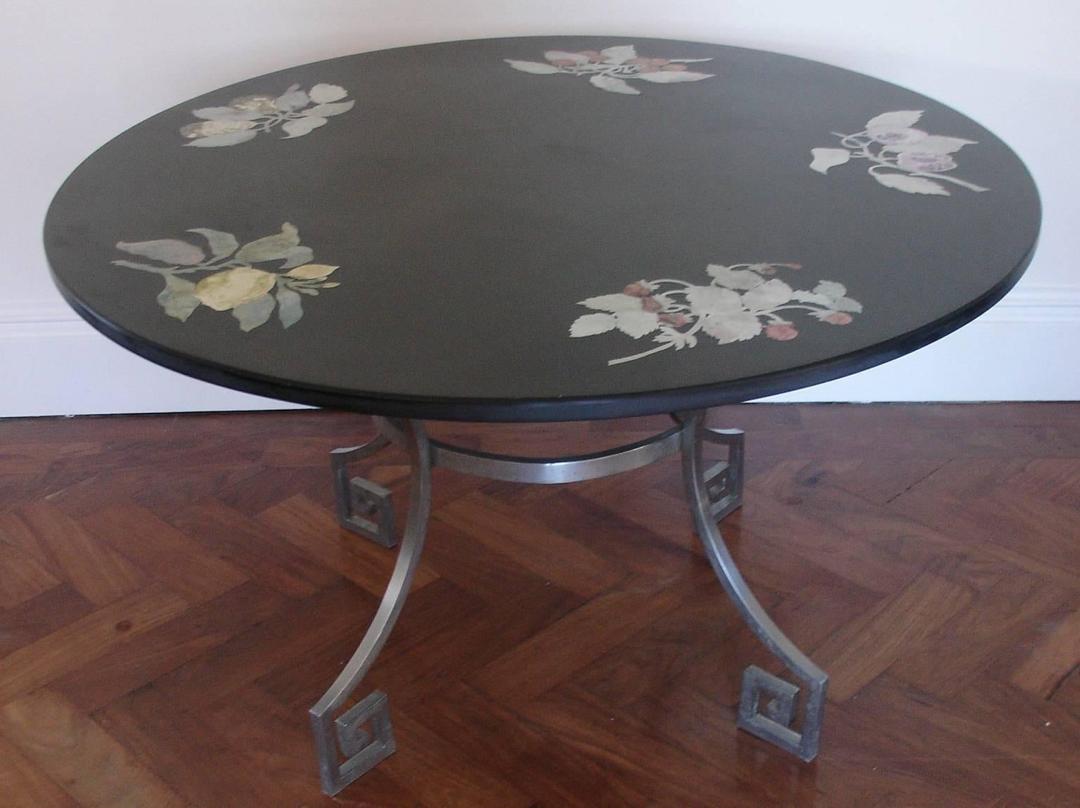 An Italian slate top side/coffee/sofa table with inset flower motifs, hand-painted. The top has the original makers label on the underside. Florentine and made in 1961. Base is brushed steel with Greek key detail.