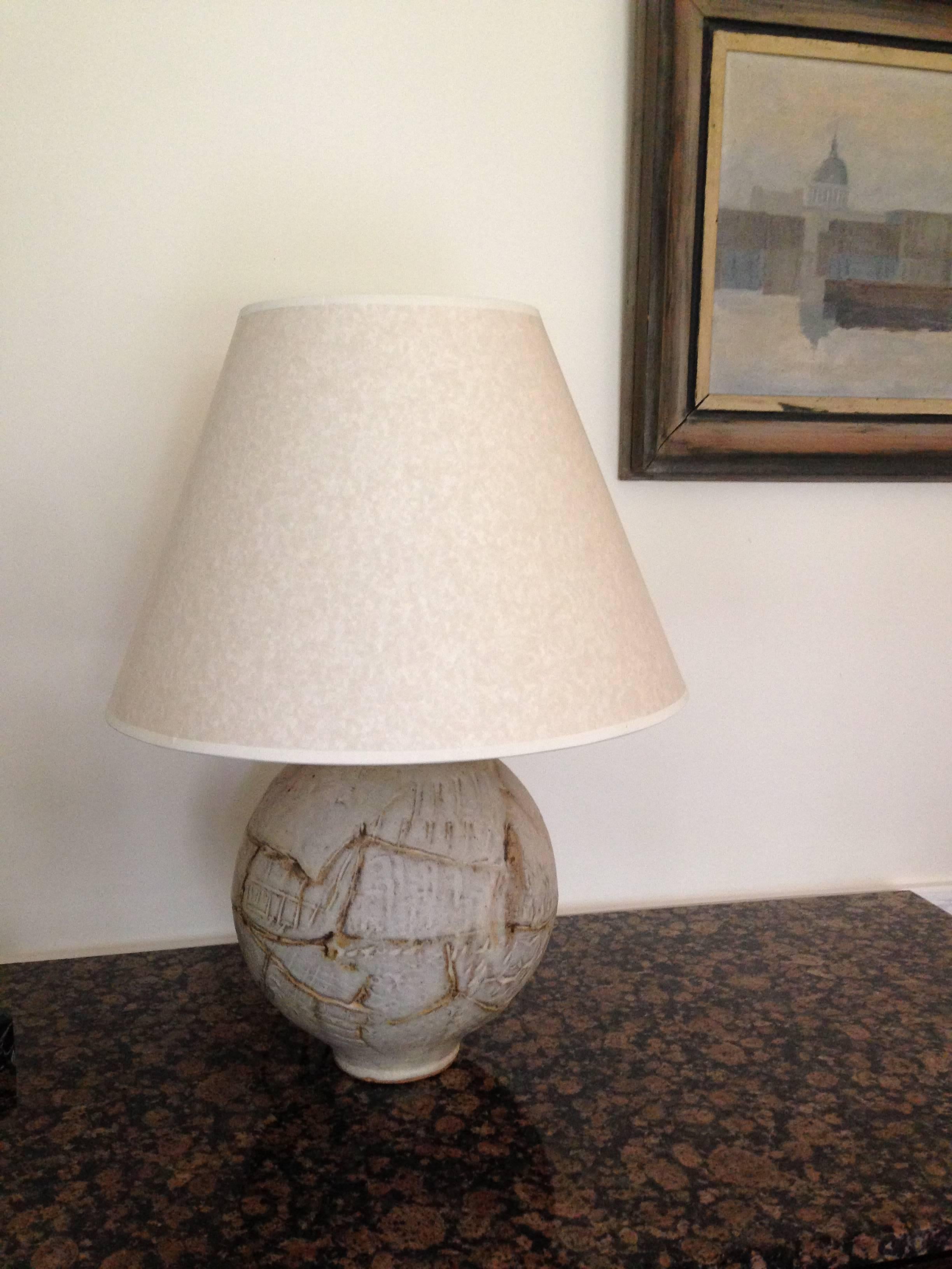 An interesting spherical heavy table lamp with incised abstract motifs.