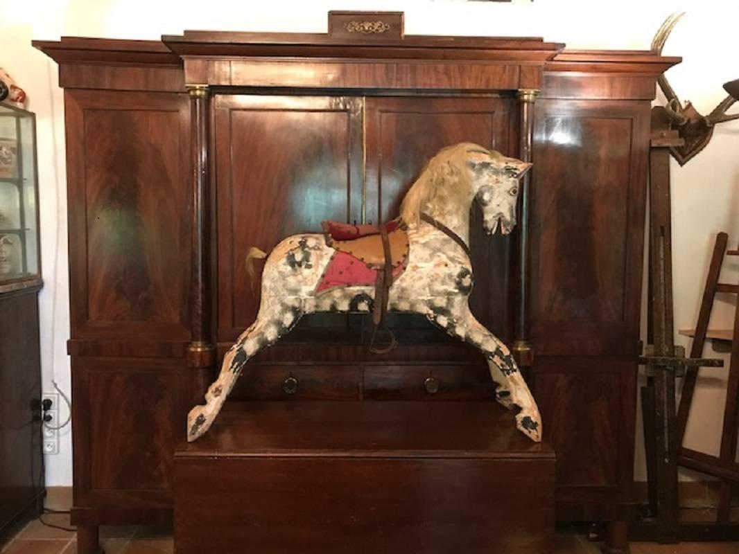 A wonderful former rocking horse, now used as a decorative object. Original paint color and hair.