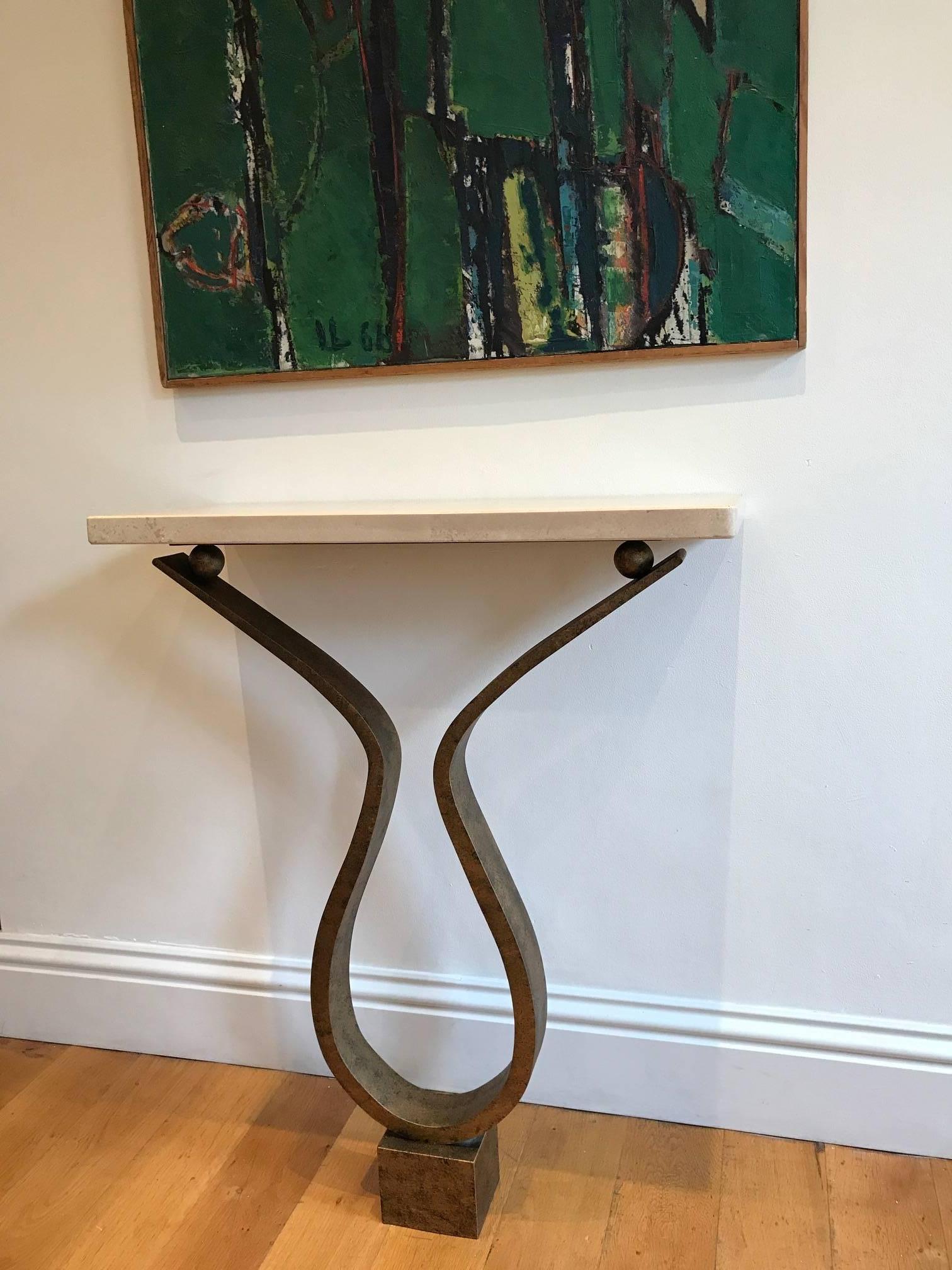 A very elegant bespoke handmade console or side table. The metalwork has a gilt / bronze finish and the top is Italian filled travertine.