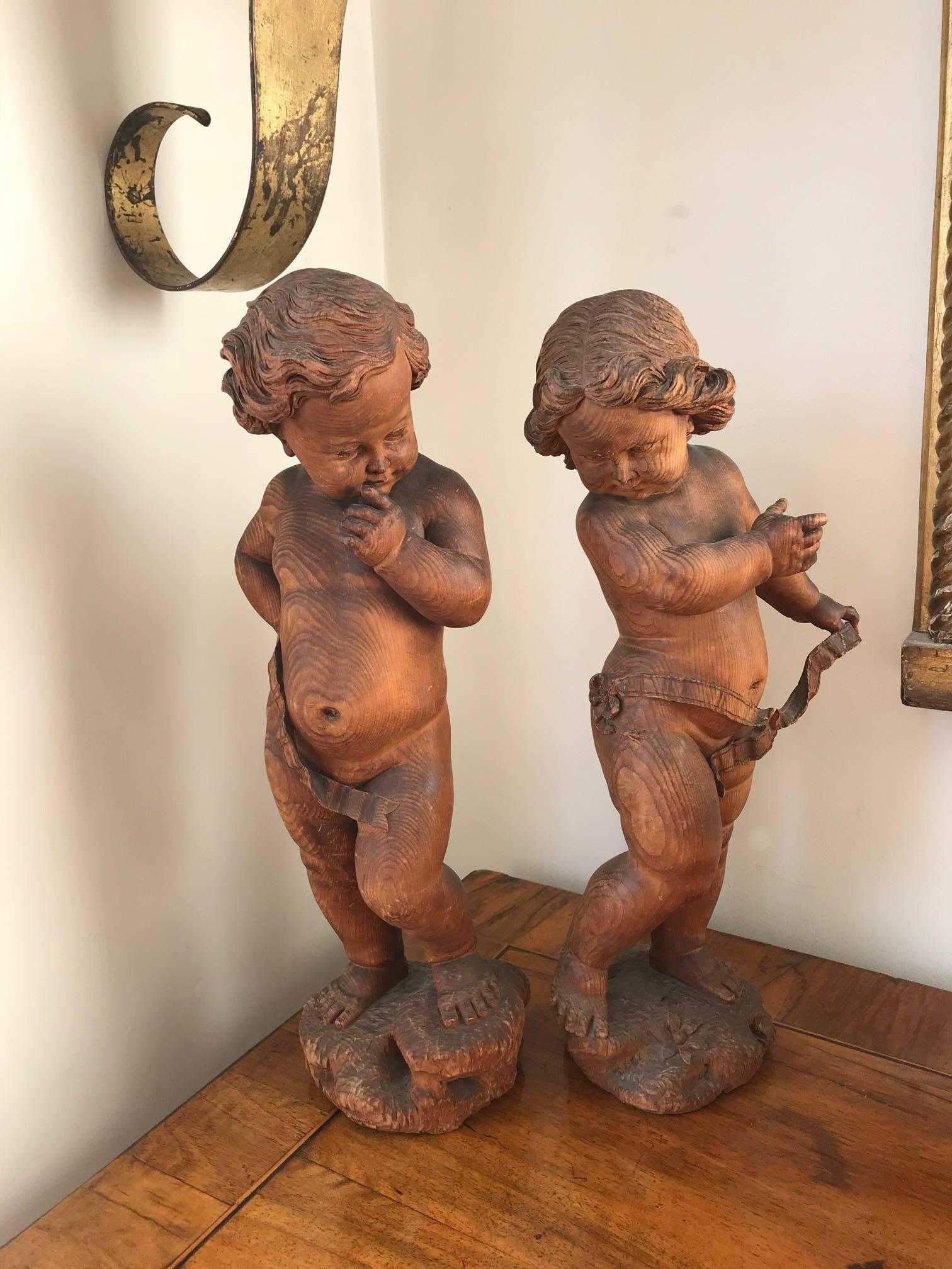 A wonderful pair of pitch pine woodend sculpures by the reknowned Venezian sculptor Valentino Besarel Panciera. Both of the sculptures are signed V Besarel Venezia and are beautifully carved into ths soft wood. There are some damage to the little