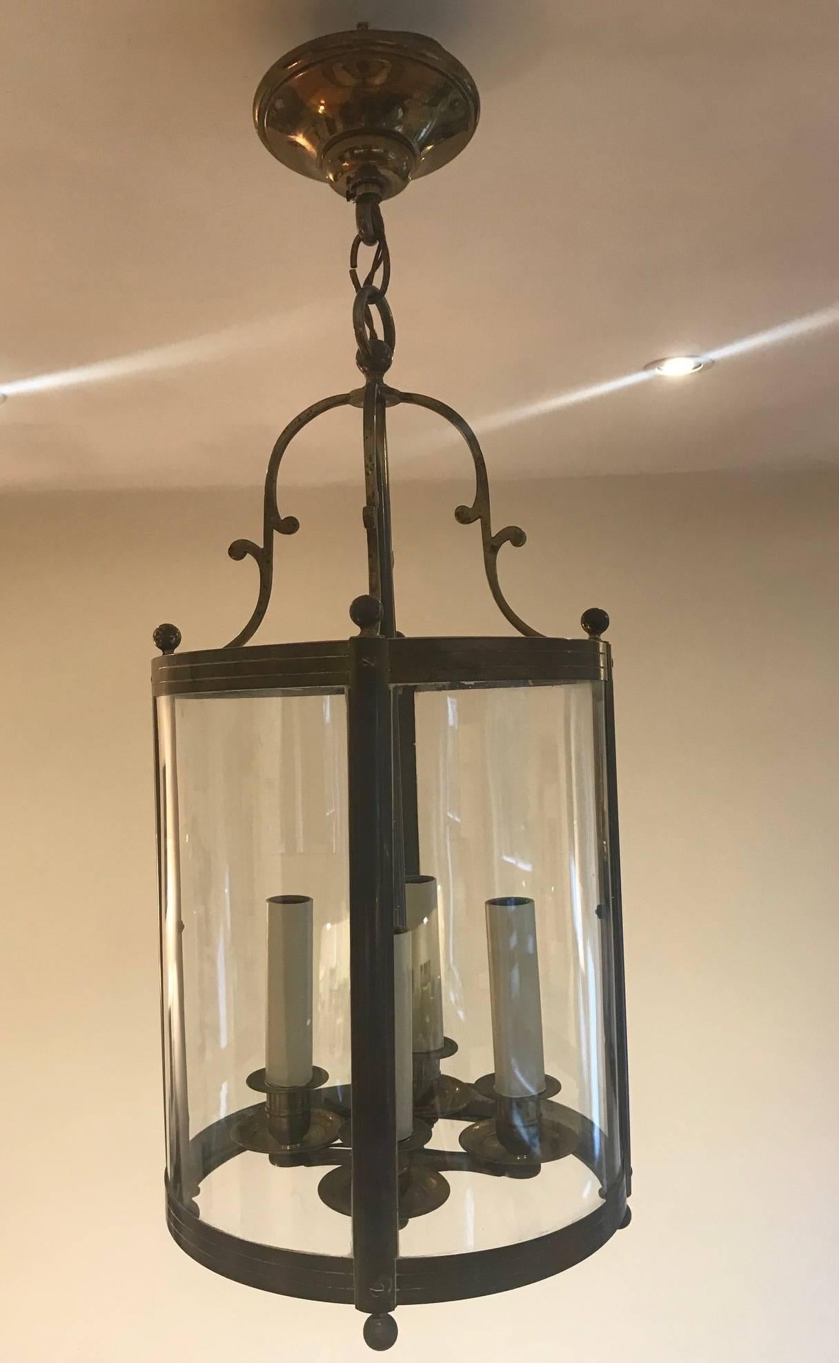 A very good quality 1940s bronze and glass hall lantern with integrated central four candle bulb holder.