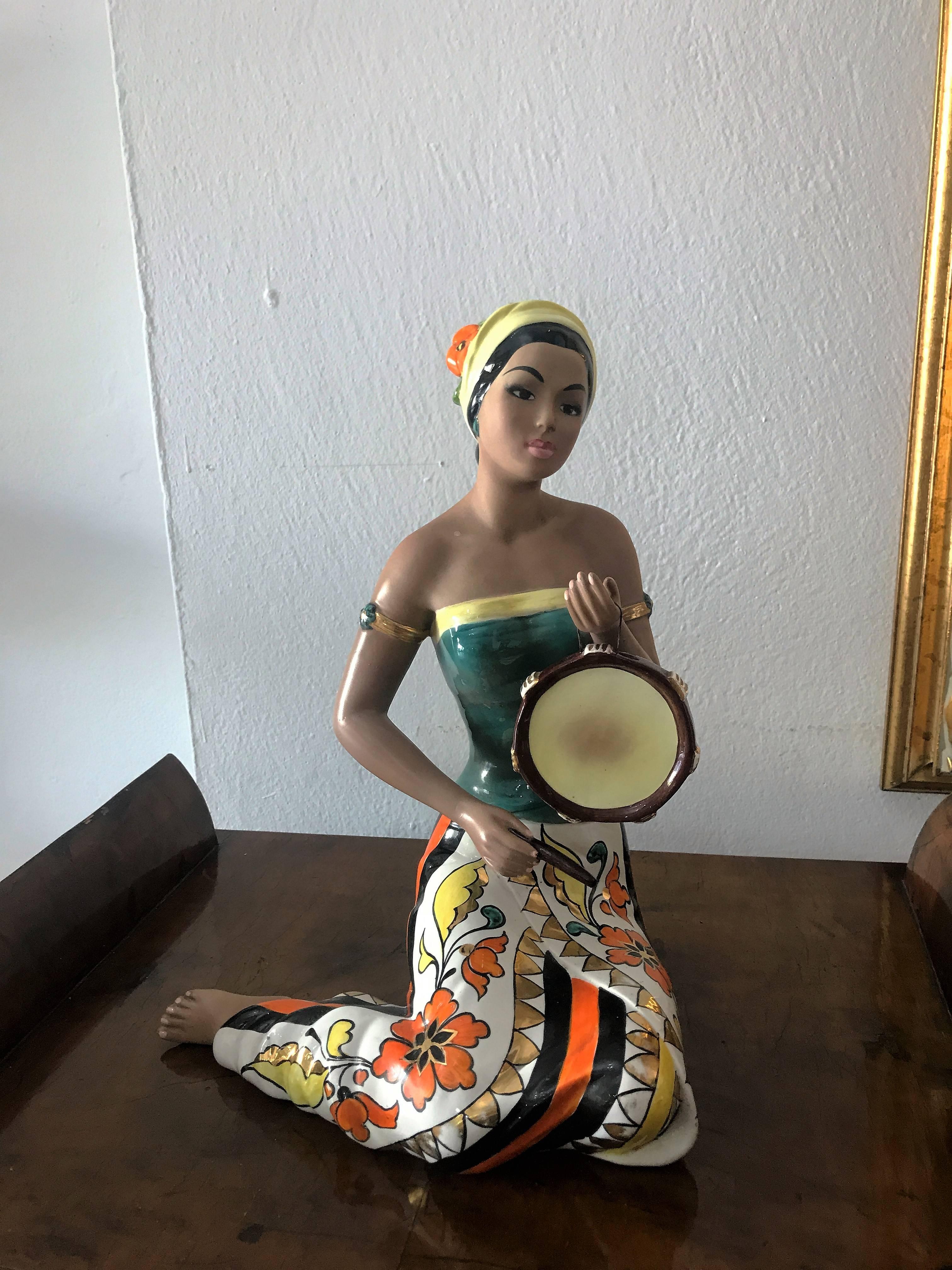 Beautiful ceramic statue, painted entirely by hand.
Female statuette playing tambourine.
Note the features of the face, details of the skirt. Really special in everything.
Stamped, signed and numbered under the base.
The statue has been restored