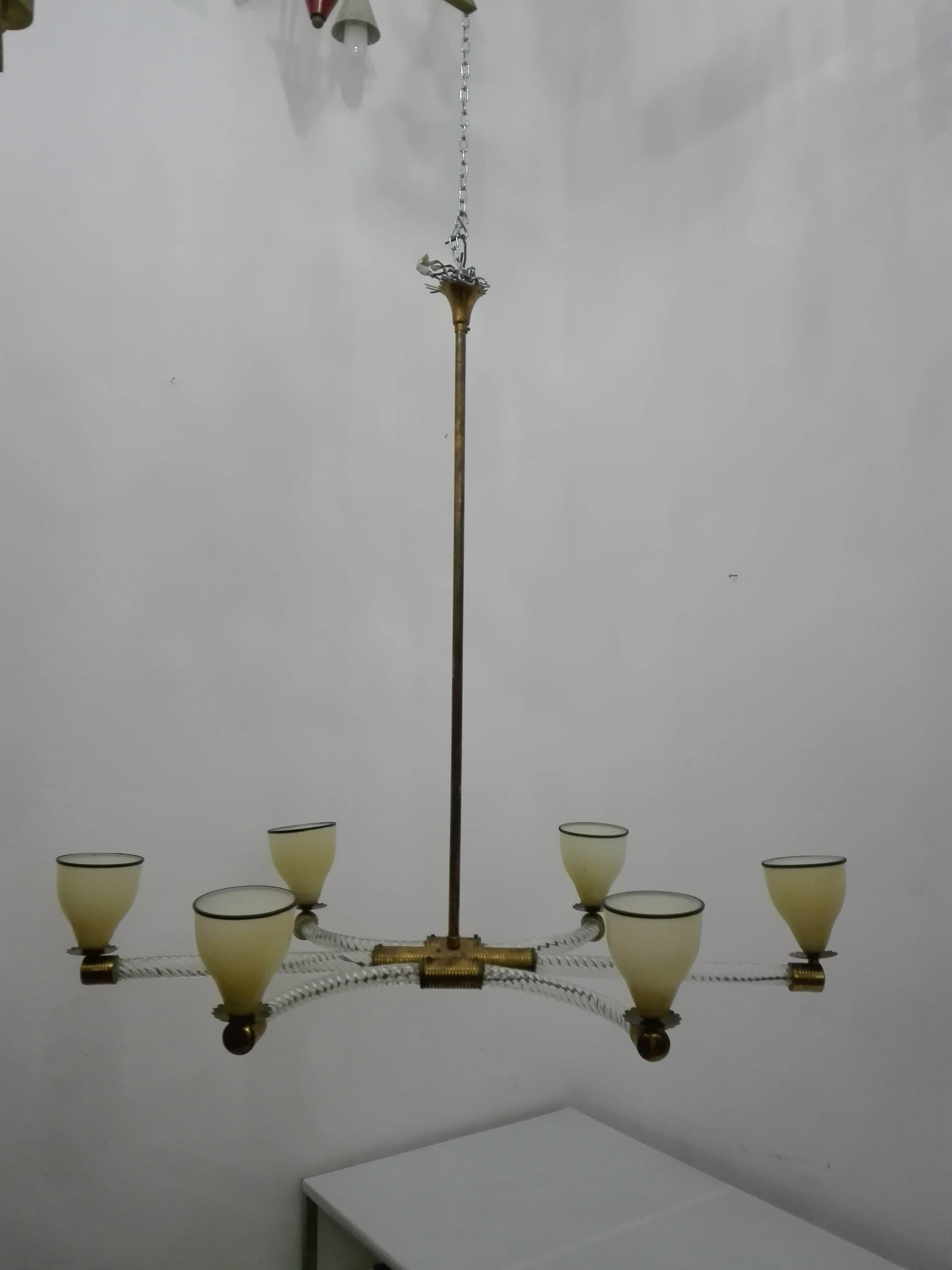 Venetian glass suspension with glass canopy. Perfect for a dining table. The decorative globe in the middle holds a brass middle section from which six Venini glass arms and sconces make an elegant curve downwards.