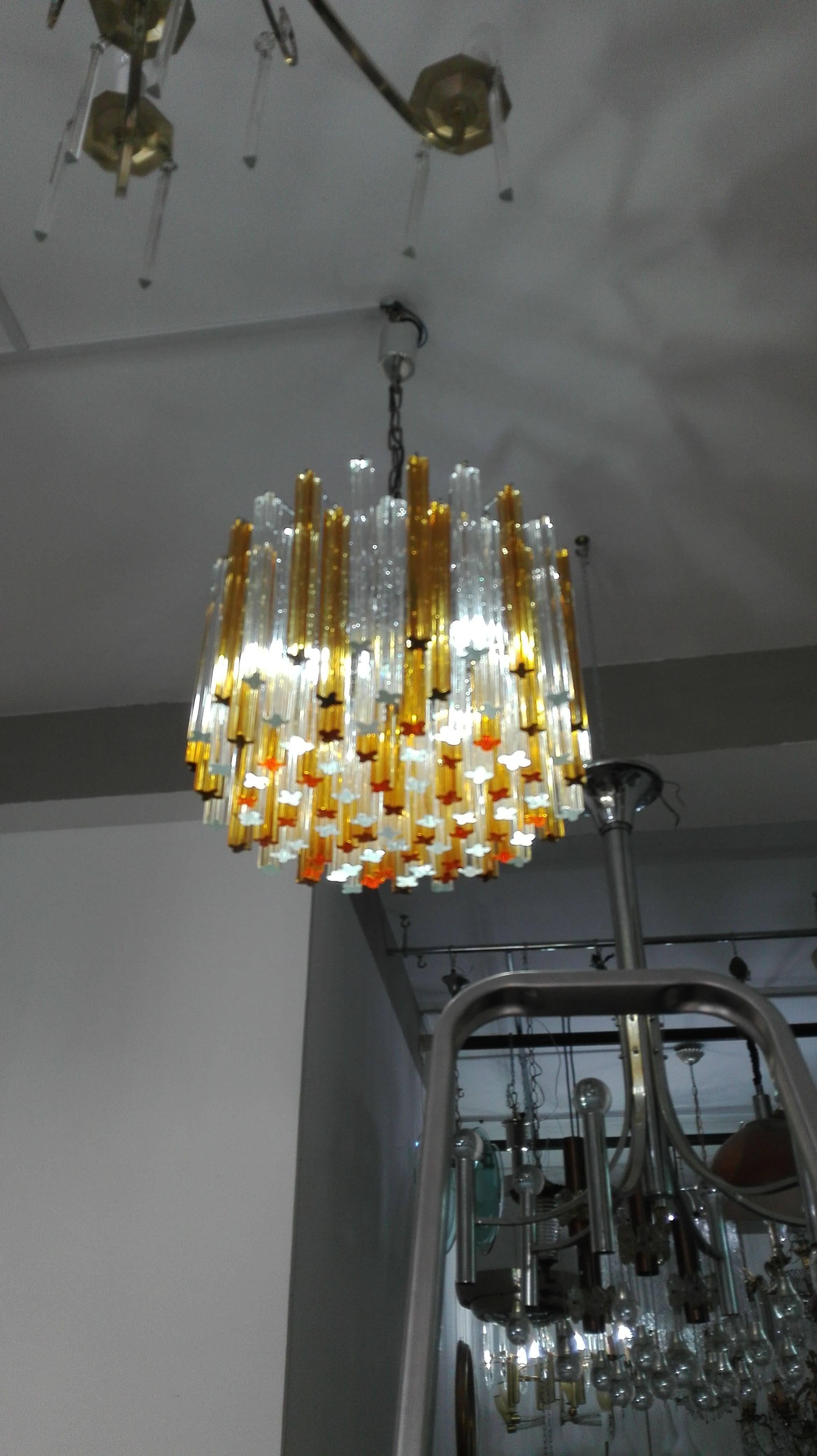 Pair of midcentury Italian chandelier by Venini with multi-level waterfall prisms. Composed of gold and clear crystals, circa 1960. Any quantity of chain can be added for custom pendant length of the chandelier. It comes with the corresponding